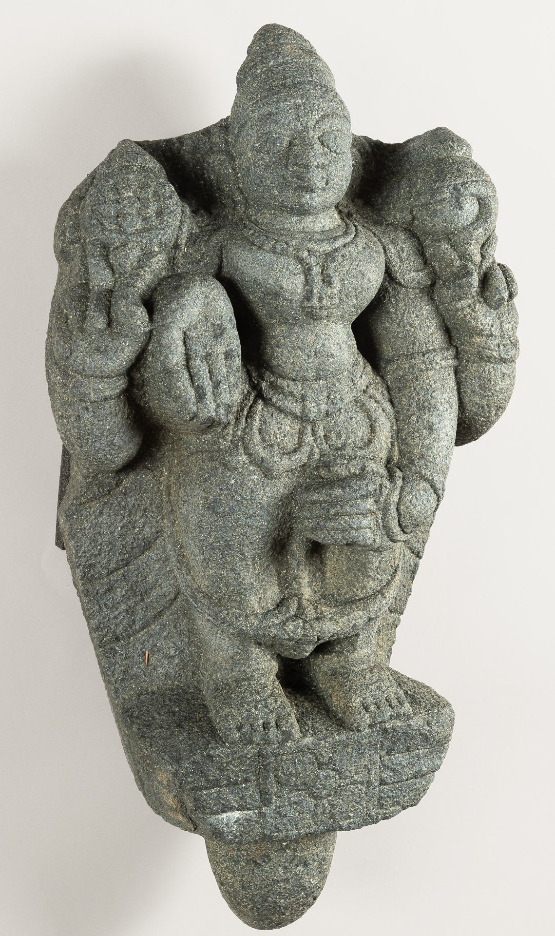 A LARGE INDIAN STONE STATUE OF A DEITY