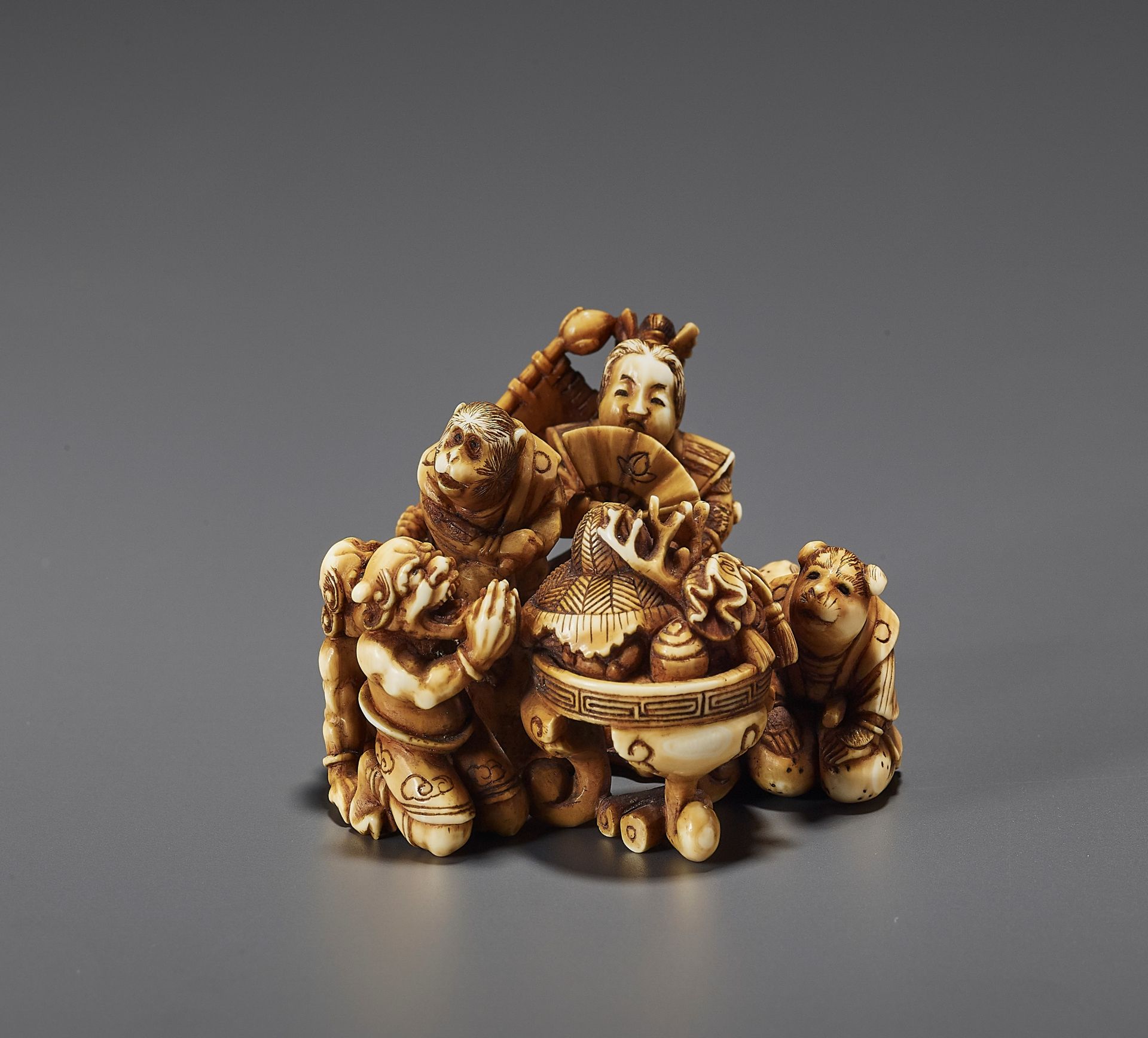 AN IVORY NETSUKE OF THE LEGEND OF MOMOTARO BY MITSUO