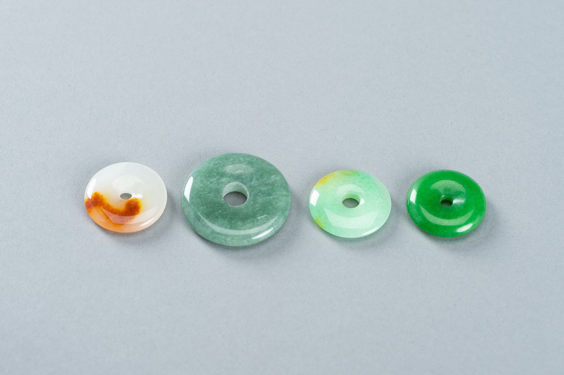 A GROUP OF FOUR JADEITE DISC PENDANTS - Image 8 of 10