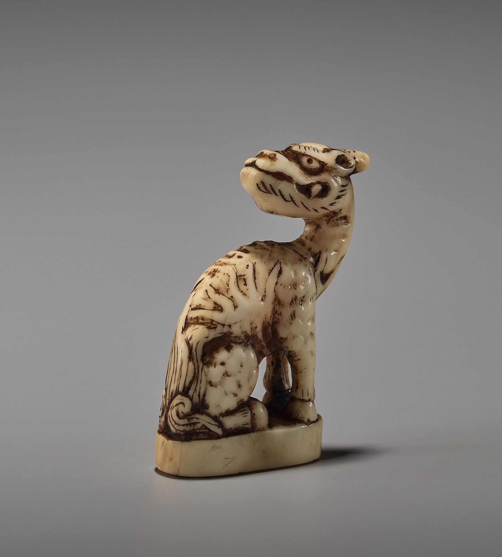 A RARE MARINE IVORY INGYO NETSUKE OF A KIRIN