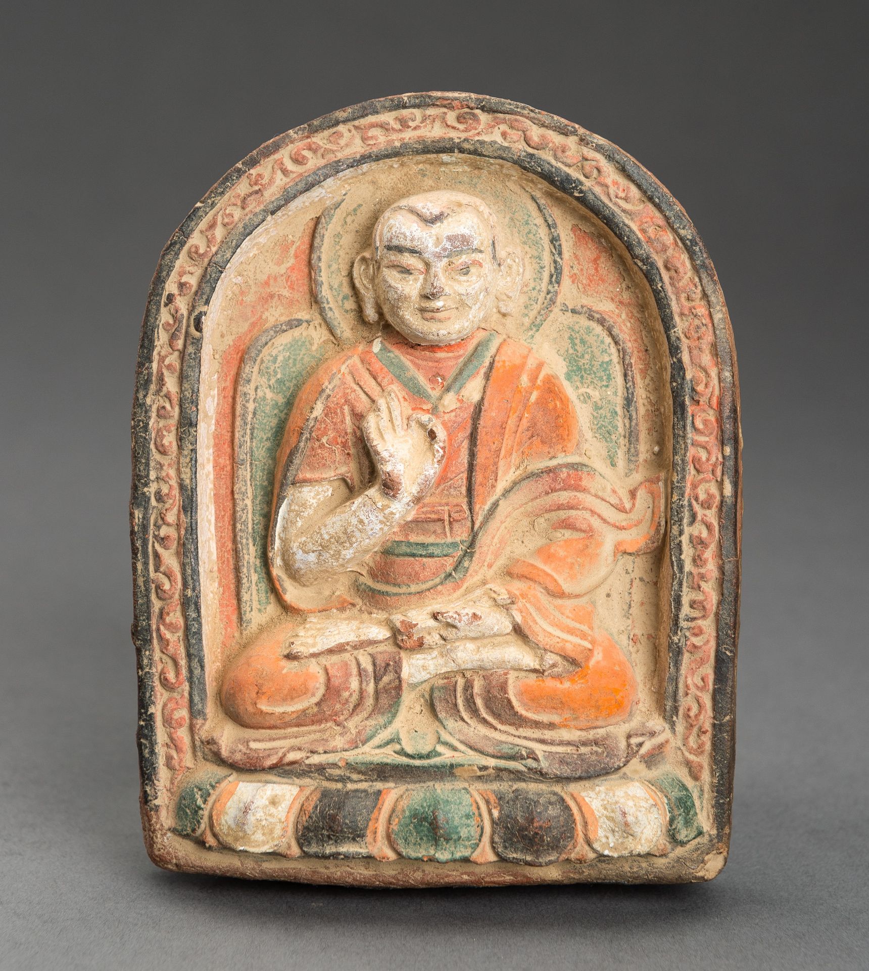 A POLYCHROME TERRACOTTA TSA TSA OF A YOUTHFUL SPIRITUAL LEADER