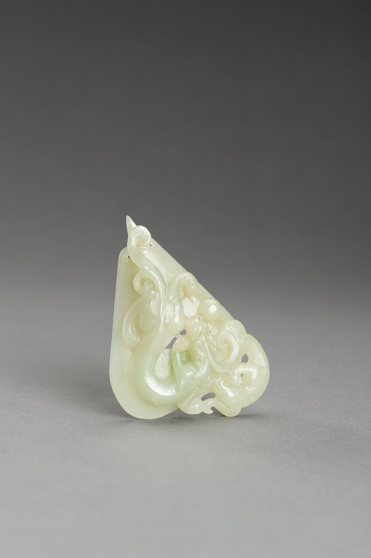 AN ARCHAISTIC PALE CELADON JADE PENDANT OF A CHILONG, 1920s - Image 13 of 14
