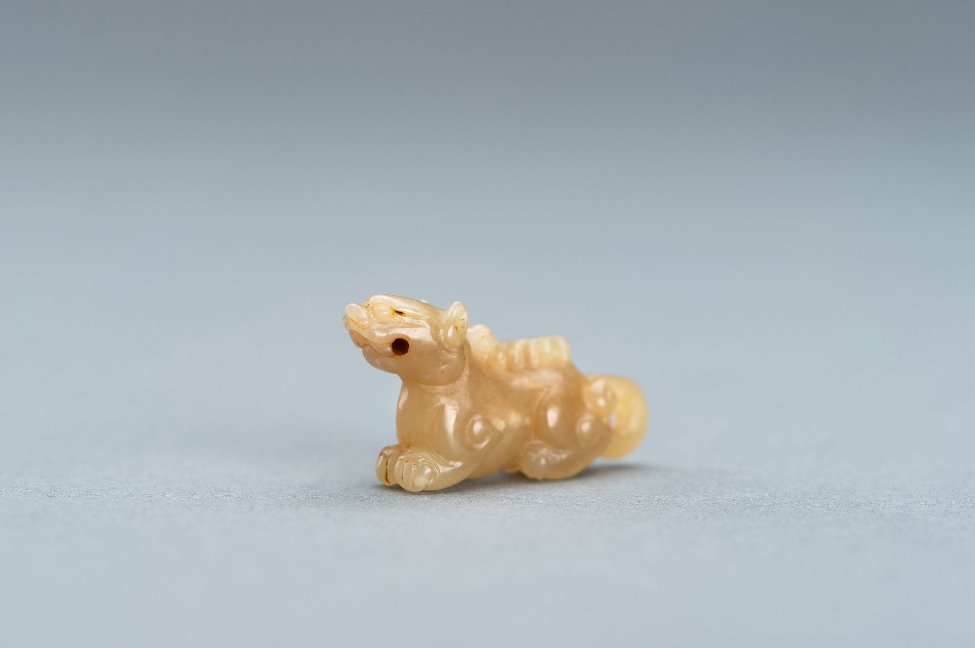 A PALE GREEN MINIATURE CARVING OF A LION, c. 1920s - Image 8 of 13