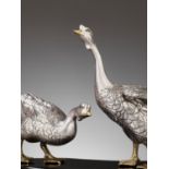 CHIKAYOSHI: A GILT AND SILVERED BRONZE OKIMONO OF TWO GEESE