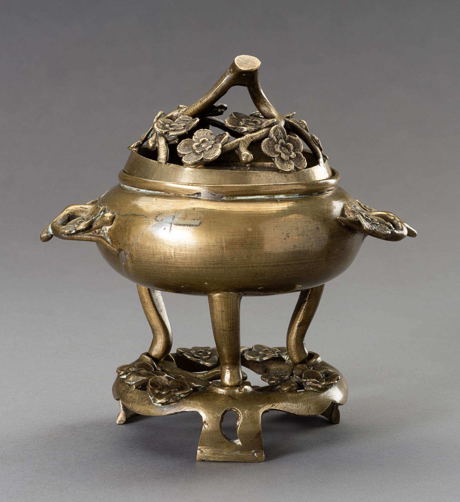 A `CHERRY BLOSSOMS' BRONZE TRIPOD CENSER WITH MATCHING STAND, QING DYNASTY