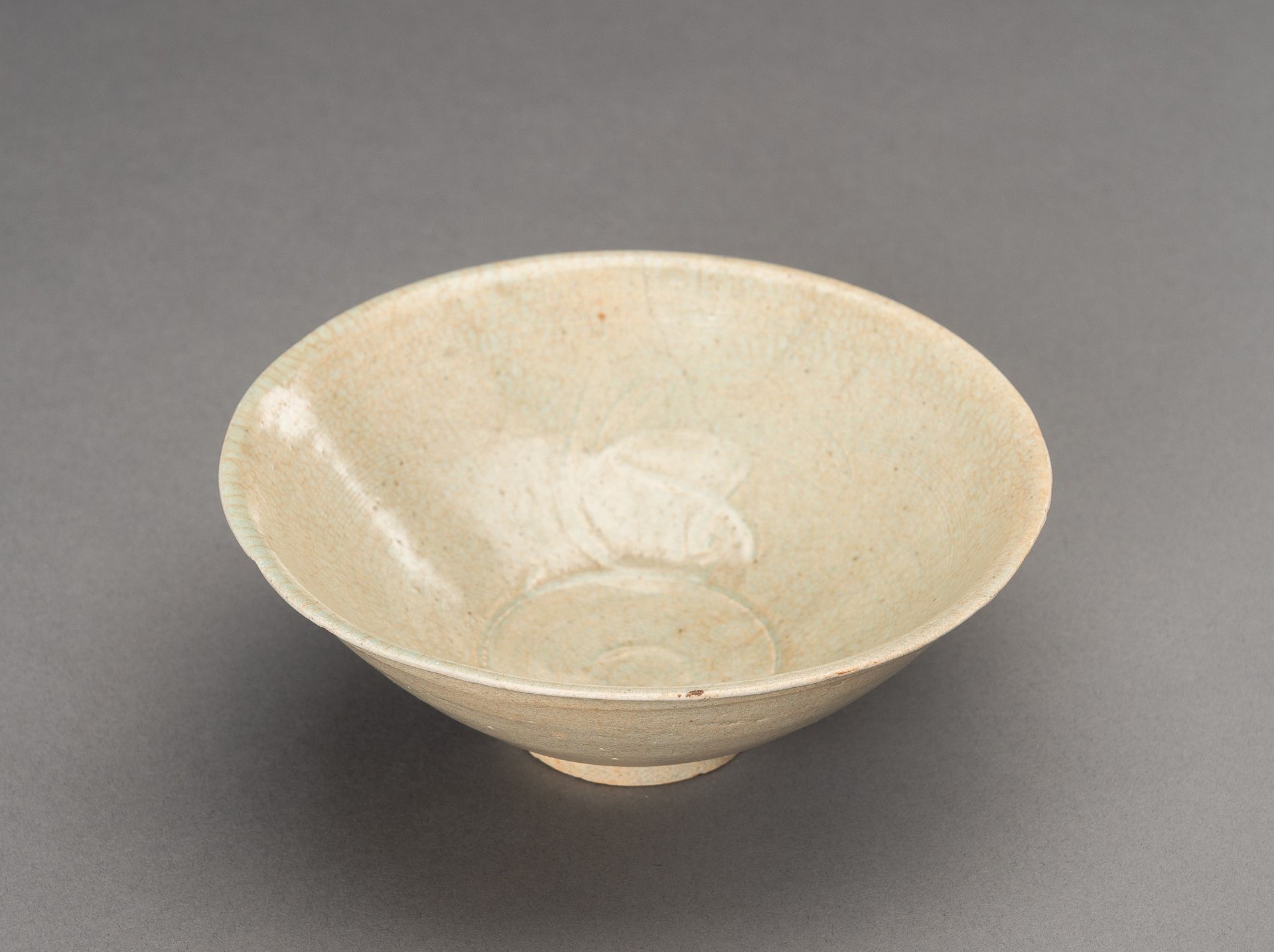 A YUAN STYLE PALE BLUE GLAZED 'TWIN FISH' PORCELAIN BOWL, 1900s