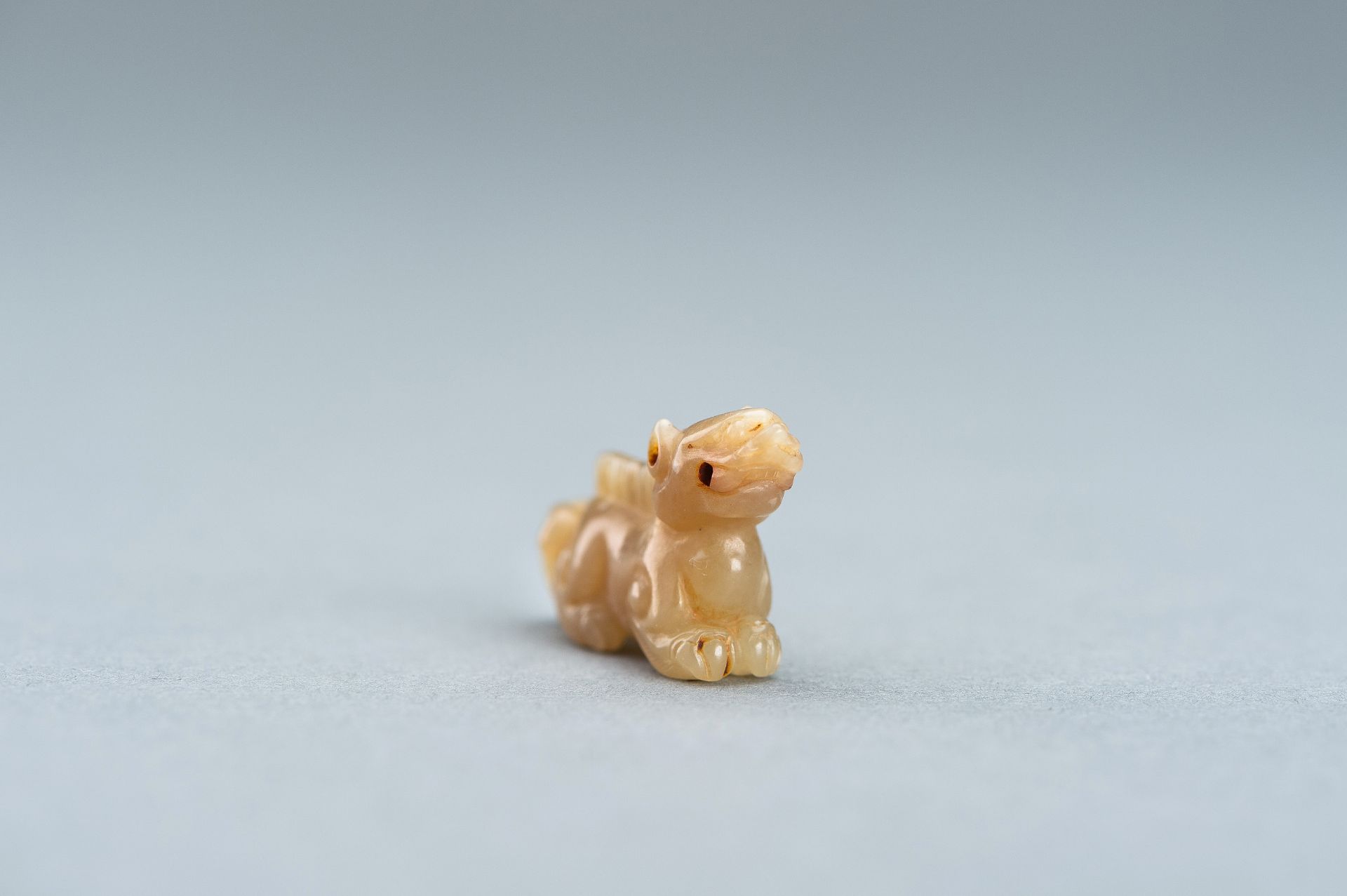 A PALE GREEN MINIATURE CARVING OF A LION, c. 1920s - Image 5 of 13