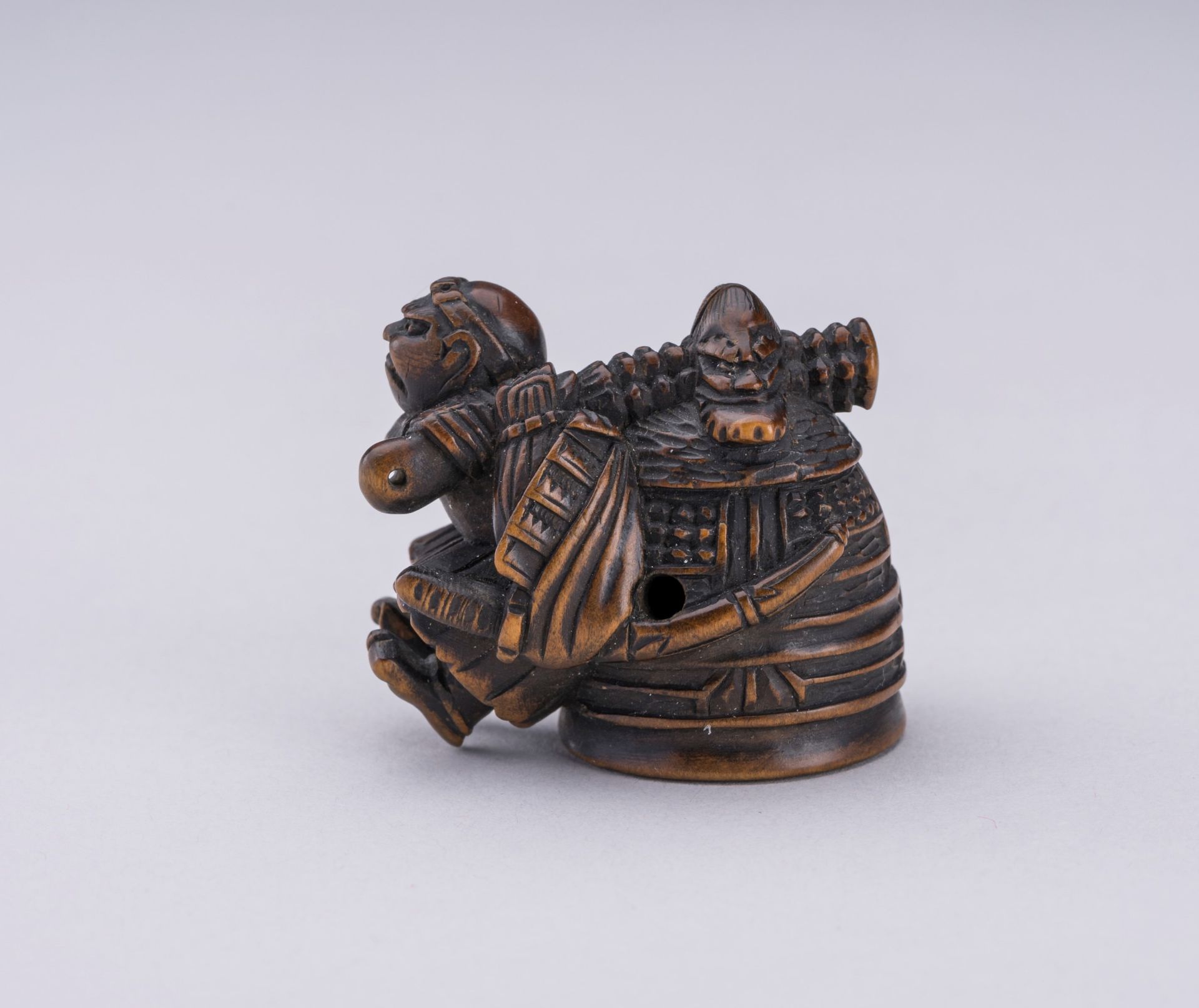 HIDEKAZU: A WOOD NETSUKE OF BENKEI CARRYING THE BELL OF MIIDERA