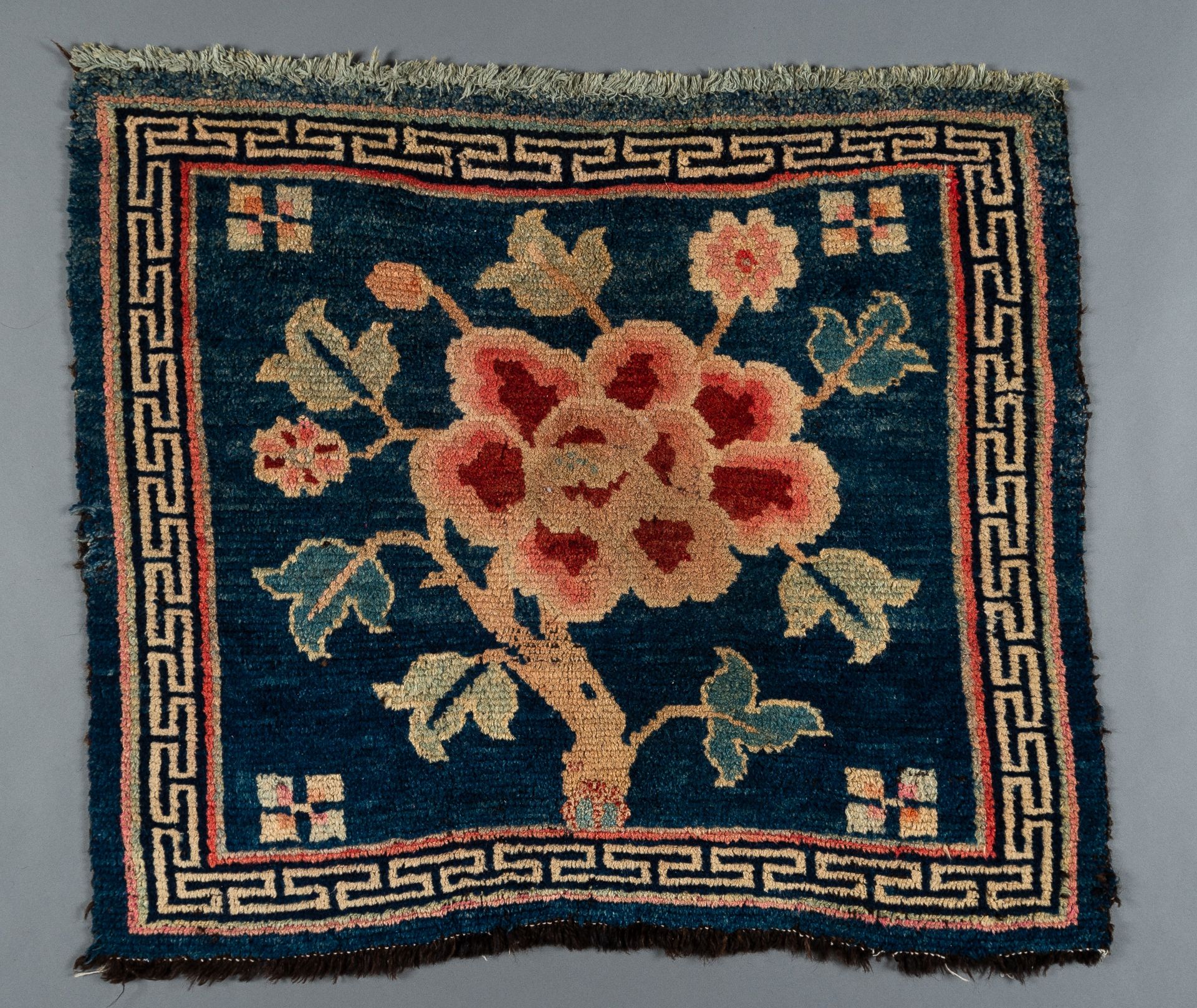 A SMALL 'FLORAL' TIBETAN RUG, c. 1900