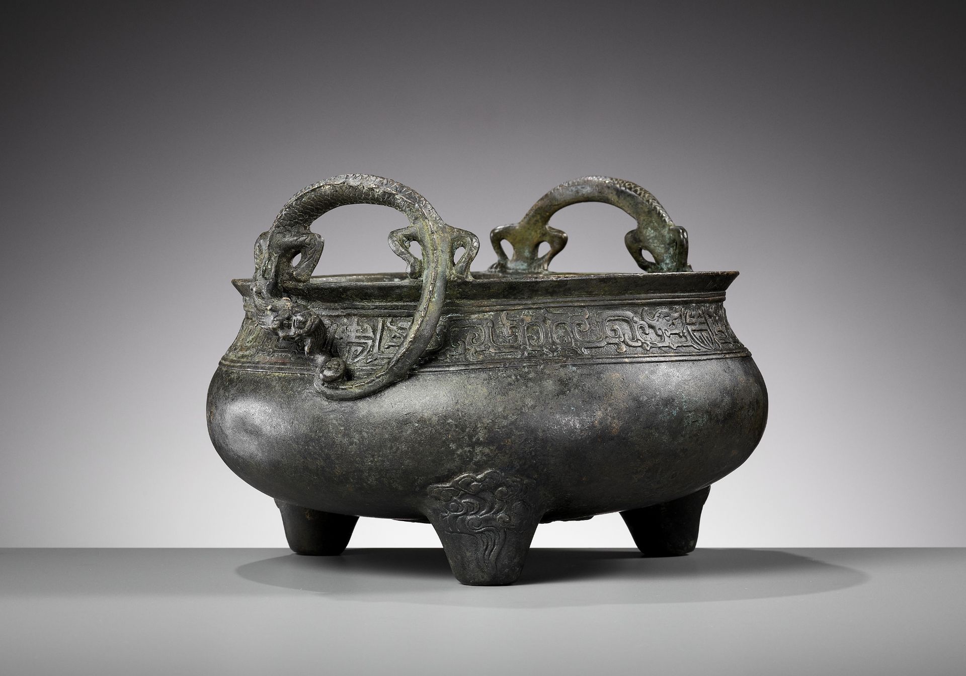 A LARGE BRONZE 'CHILONG HANDLE' TRIPOD CENSER, QING DYNASTY