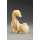 A PALE YELLOW JADE FIGURE OF A DOG, QING