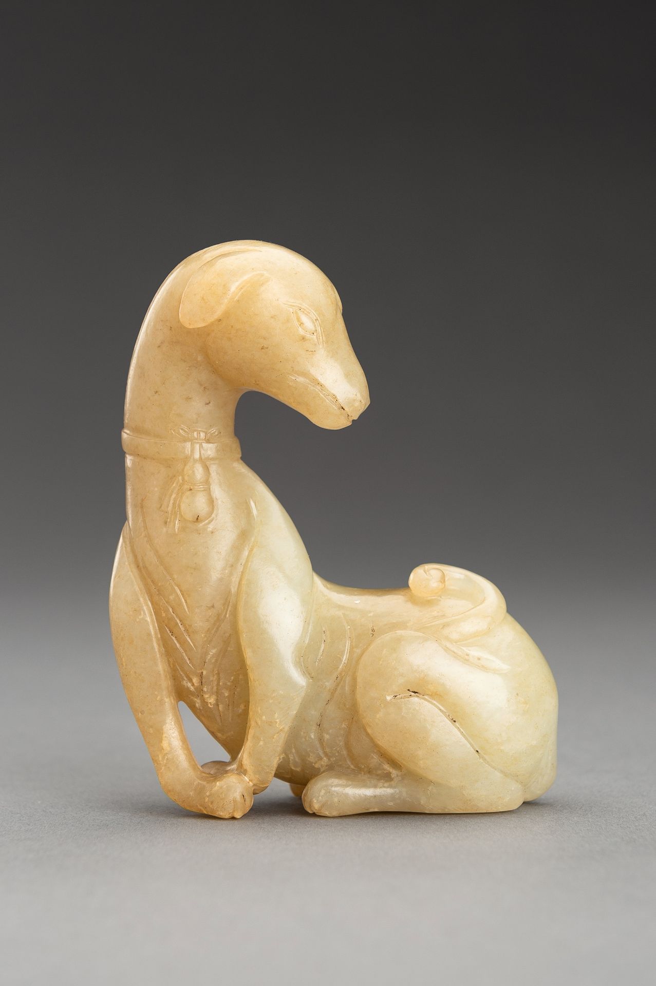 A PALE YELLOW JADE FIGURE OF A DOG, QING