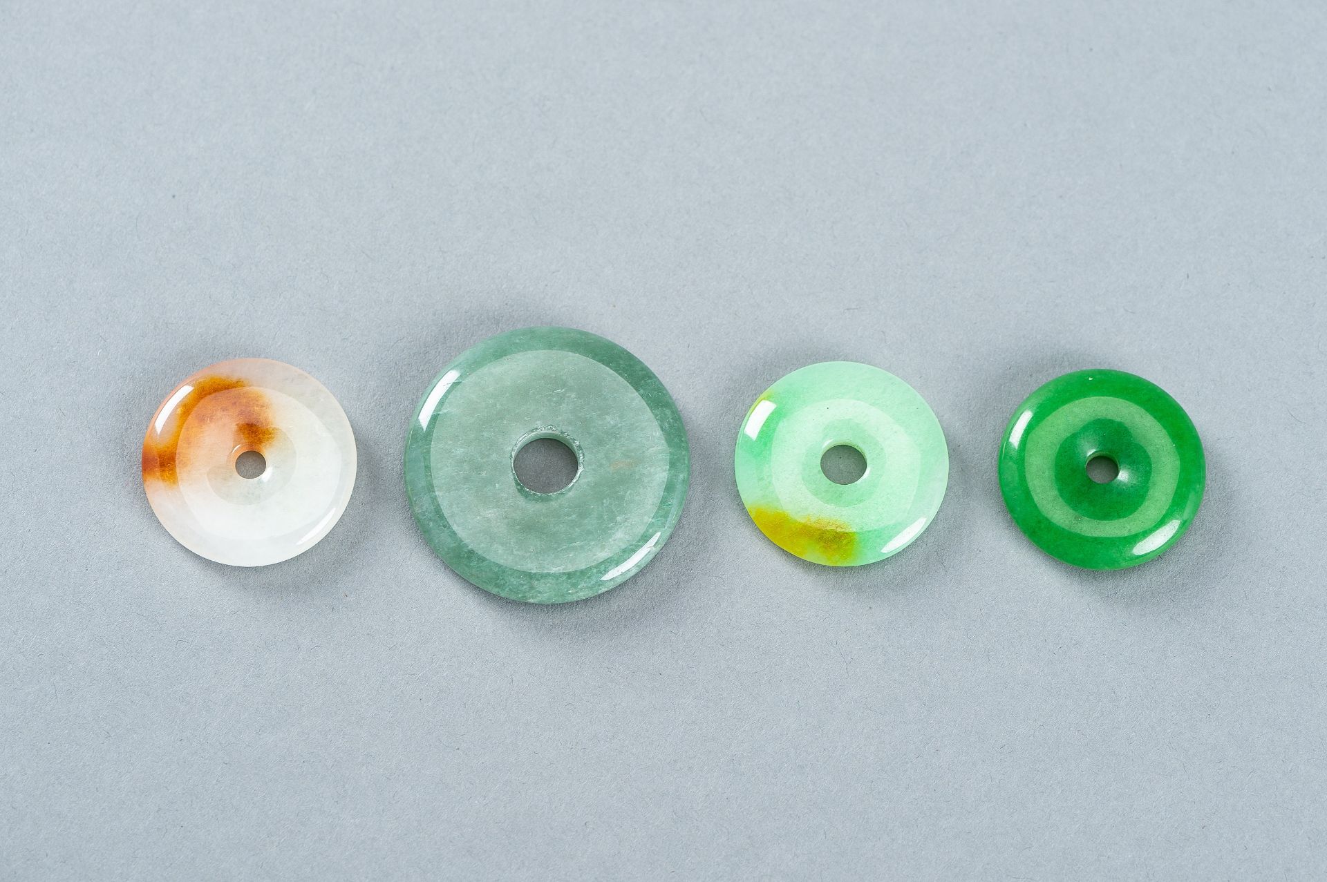 A GROUP OF FOUR JADEITE DISC PENDANTS - Image 9 of 10