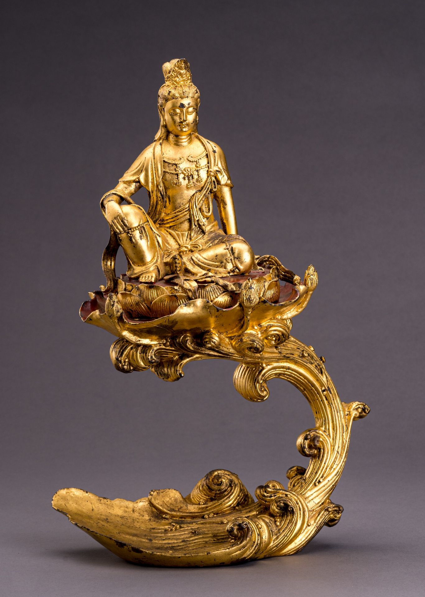 AN UNUSUAL GILT BRONZE FIGURE OF GUANYIN