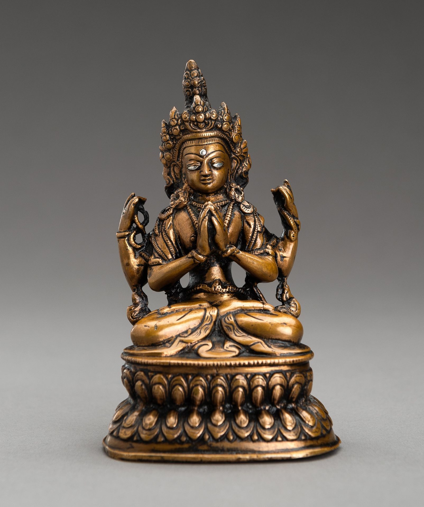 A SILVER INLAID BRONZE FIGURE OF AVALOKITESHVARA