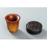 A CARVED TORTOISESHELL SNUFF BOX AND A 'RHINO HORN' IMITATION WINE CUP