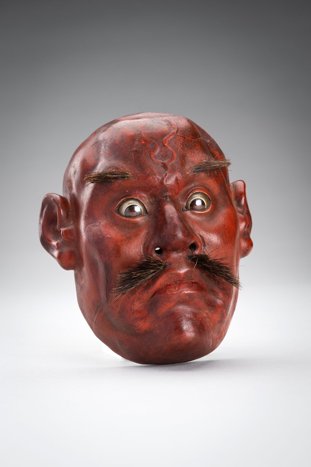 A SMALL LACQUERED WOOD MASK OF A MAN