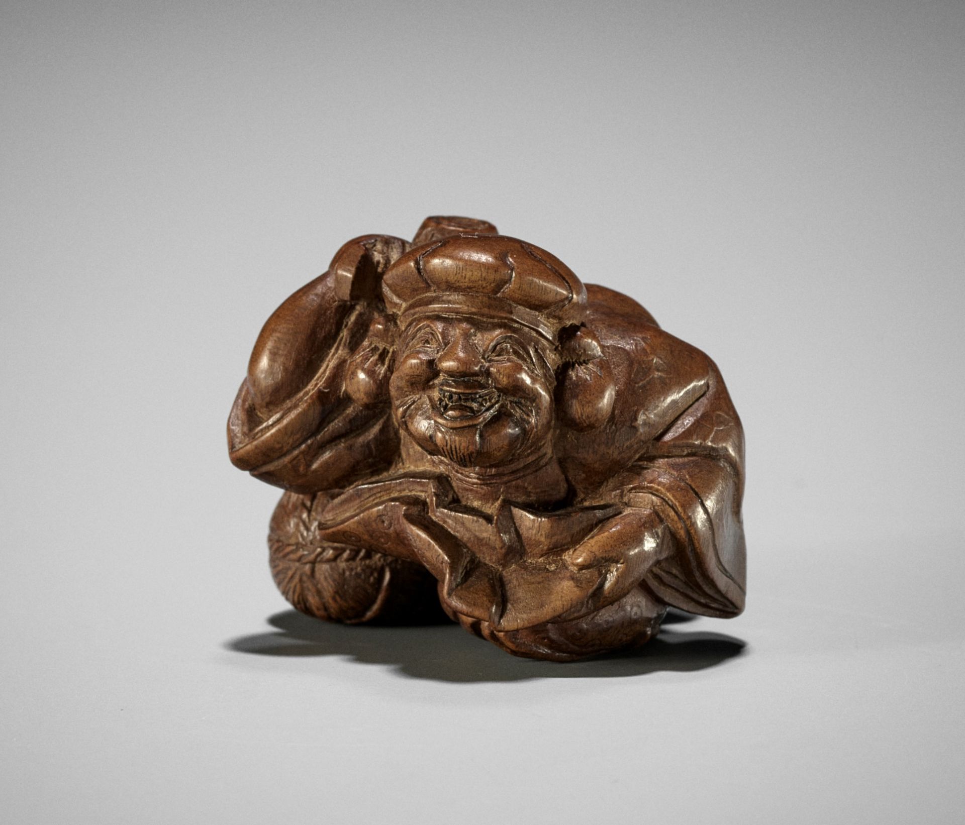 MINZAN: AN UNUSUAL WOOD NETSUKE OF DAIKOKU WITH UKIBORI DETAILS