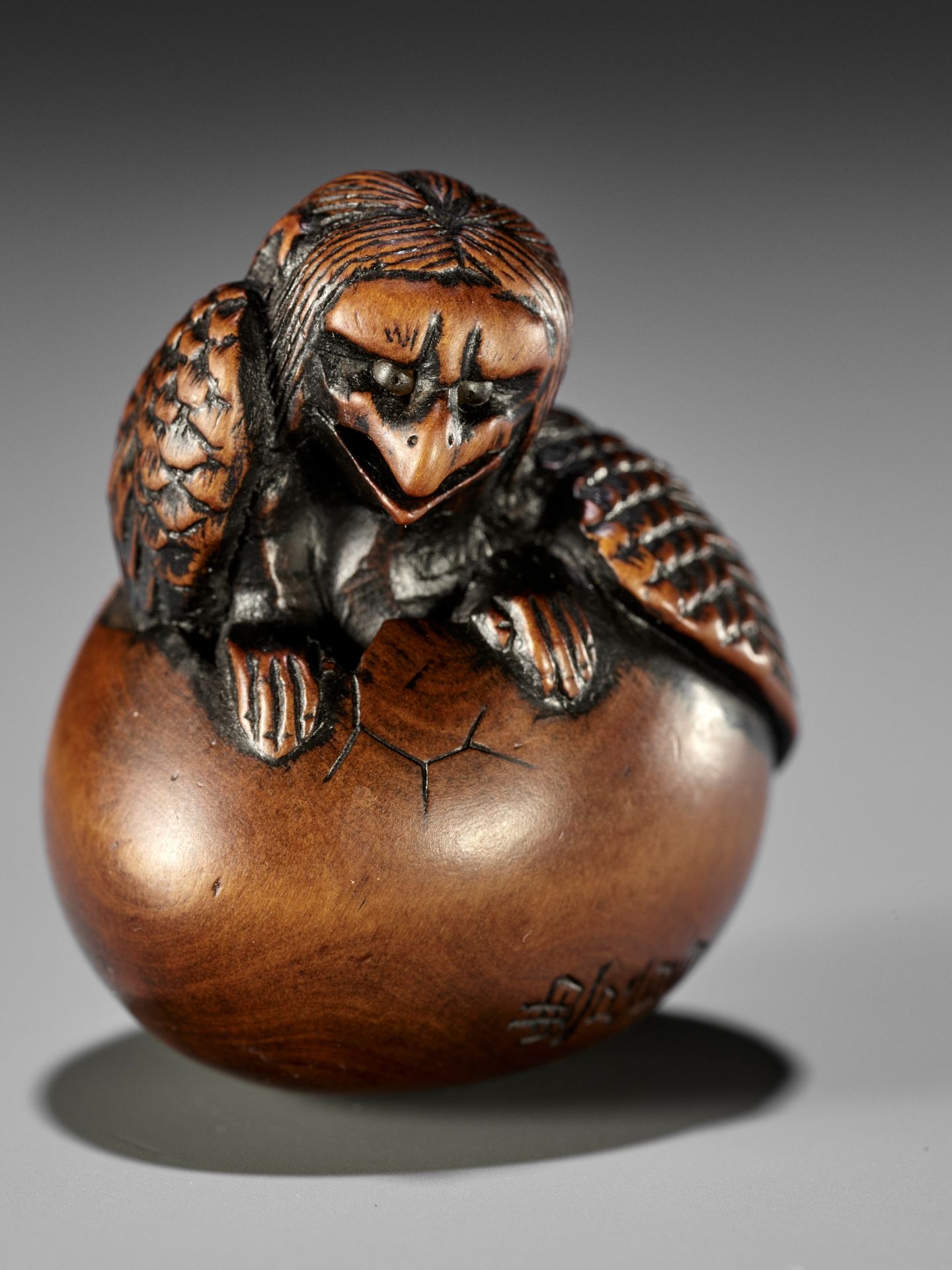 NAITO TOYOMASA: A FINE WOOD NETSUKE OF A HATCHING TENGU (TENGU NO TOMAGO)