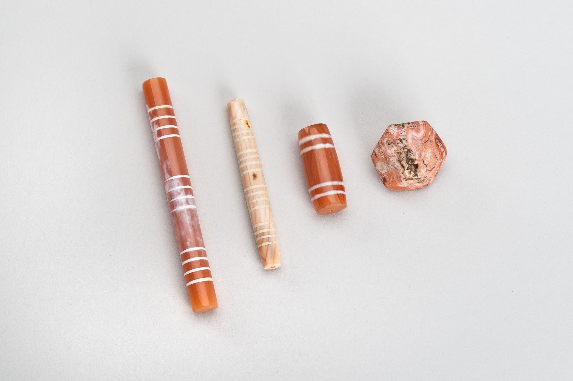 A GROUP OF FOUR ETCHED PYU CARNELIAN BEADS