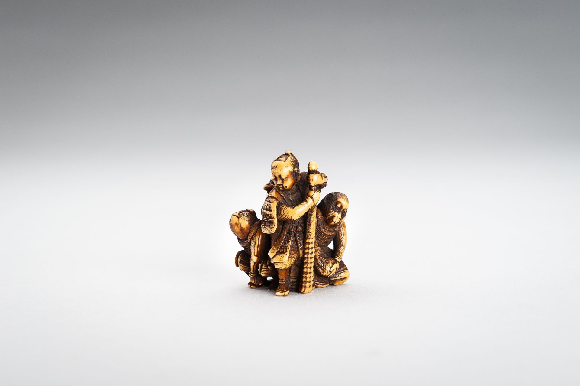 TOMOCHIKA: AN IVORY NETSUKE OF MOMOTARO WITH COMPANIONS - Image 2 of 11