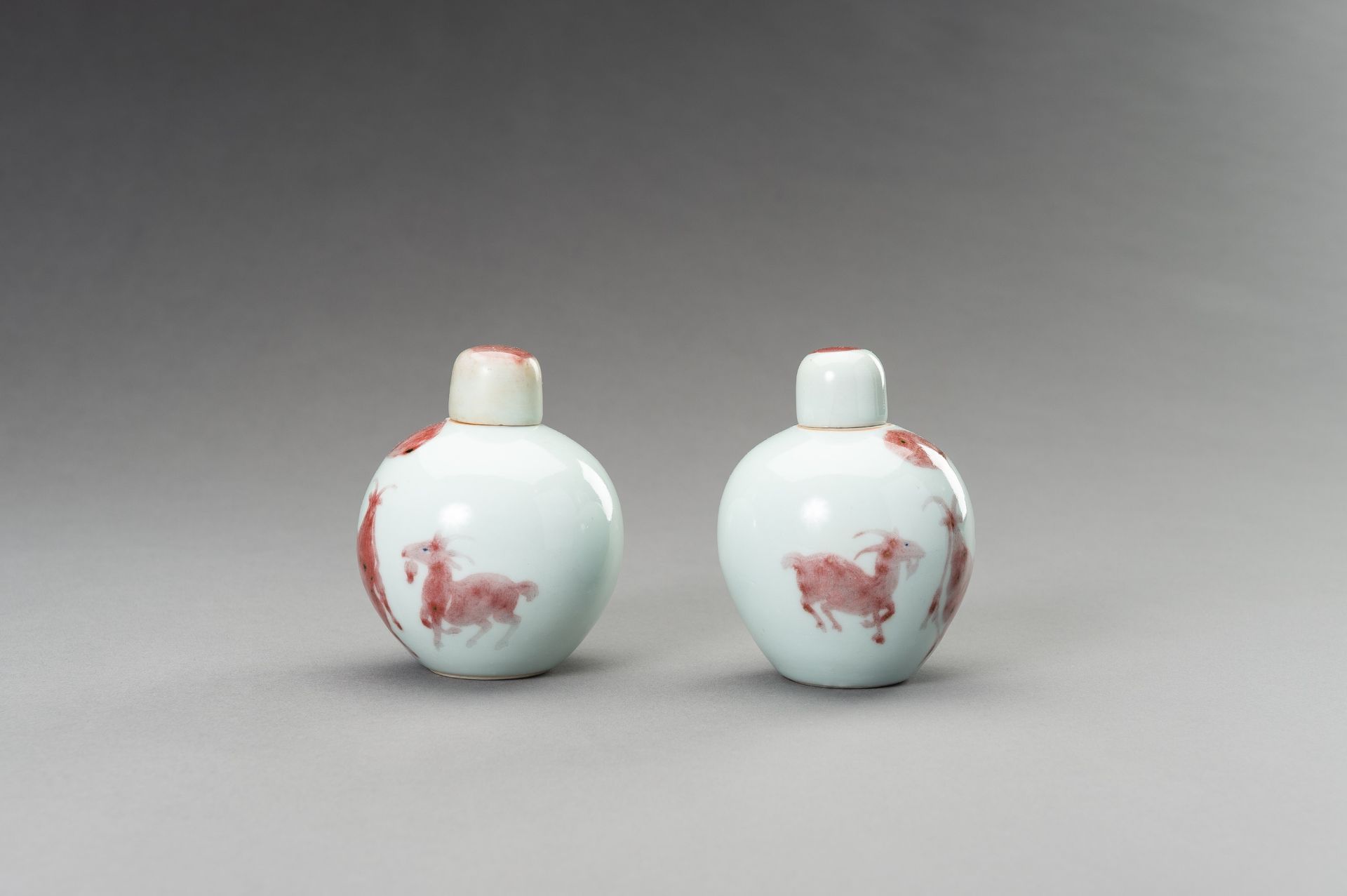 A RARE PAIR OF COPPER-RED, LIDDED PORCELAIN JARLETS DEPICTING GOATS, 1900s - Image 2 of 10