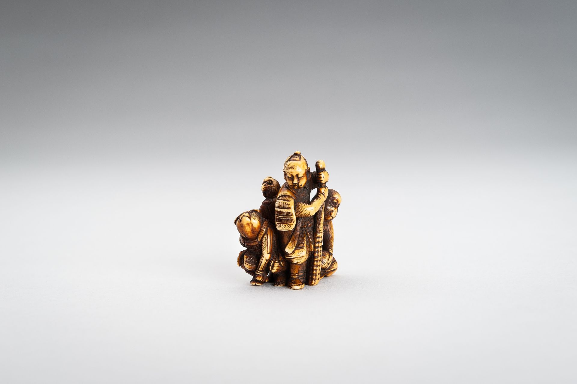 TOMOCHIKA: AN IVORY NETSUKE OF MOMOTARO WITH COMPANIONS - Image 6 of 11