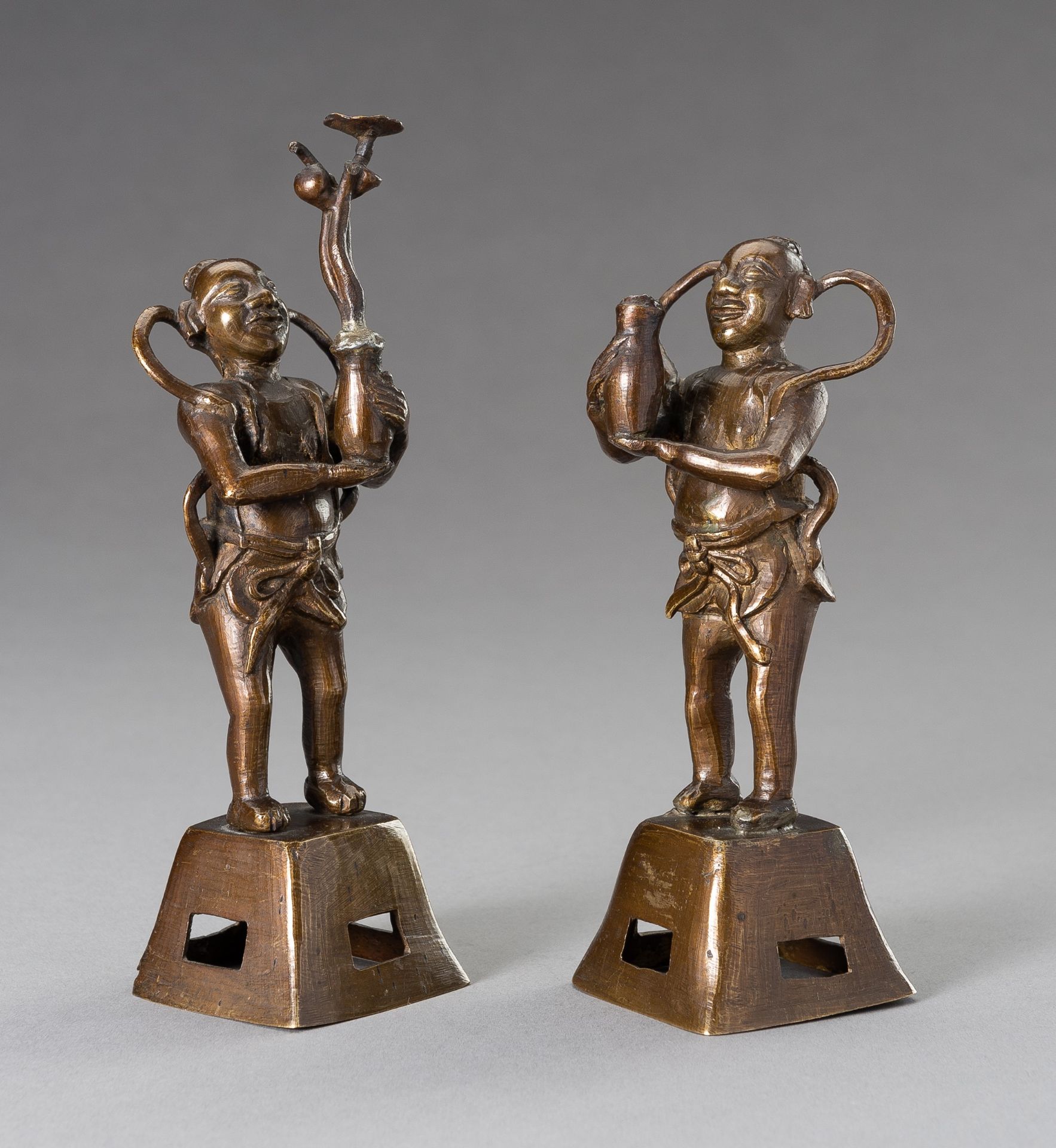 TWO BRONZE FIGURES OF BOYS HOLDING VASES