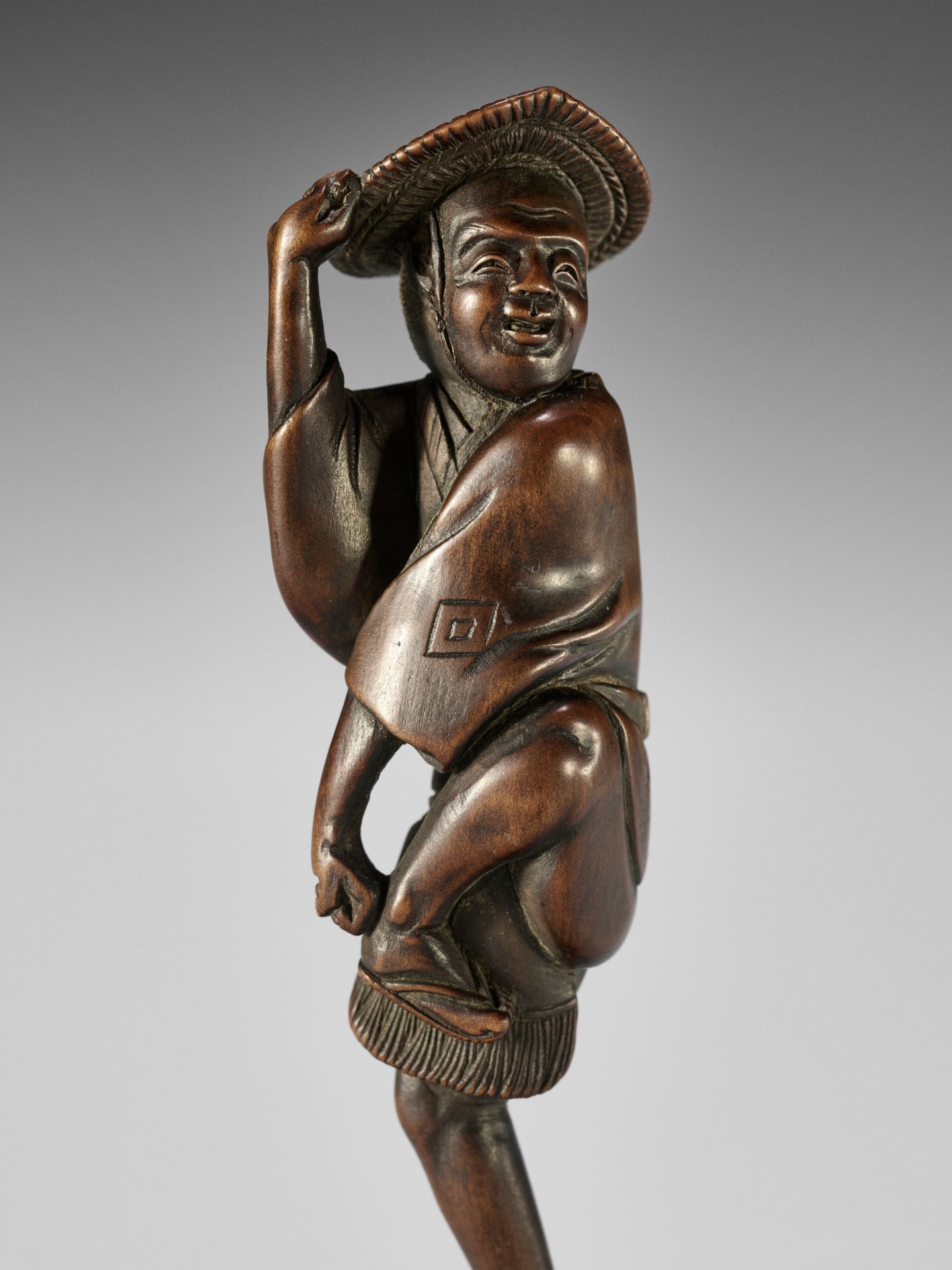 TOMOCHIKA: A SUPERB AND RARE WOOD NETSUKE OF A SPARROW DANCER (SUZUME ODORI)