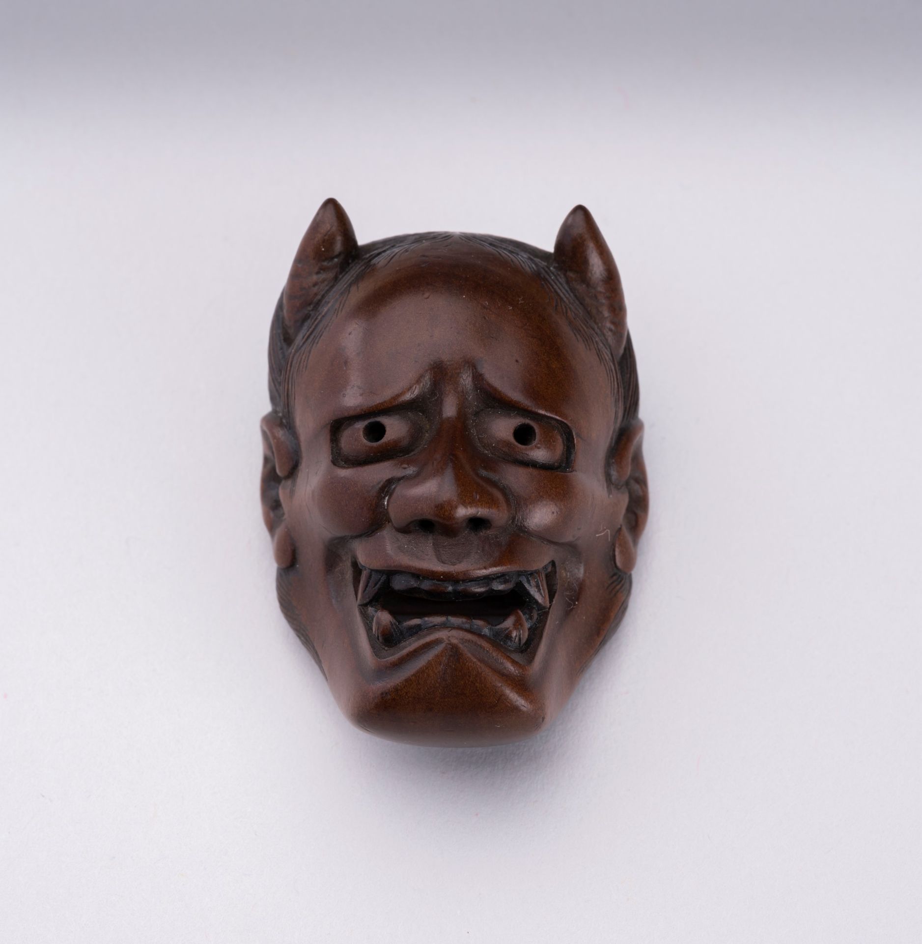 NAOAKI: A BOXWOOD MASK NETSUKE OF HANNYA