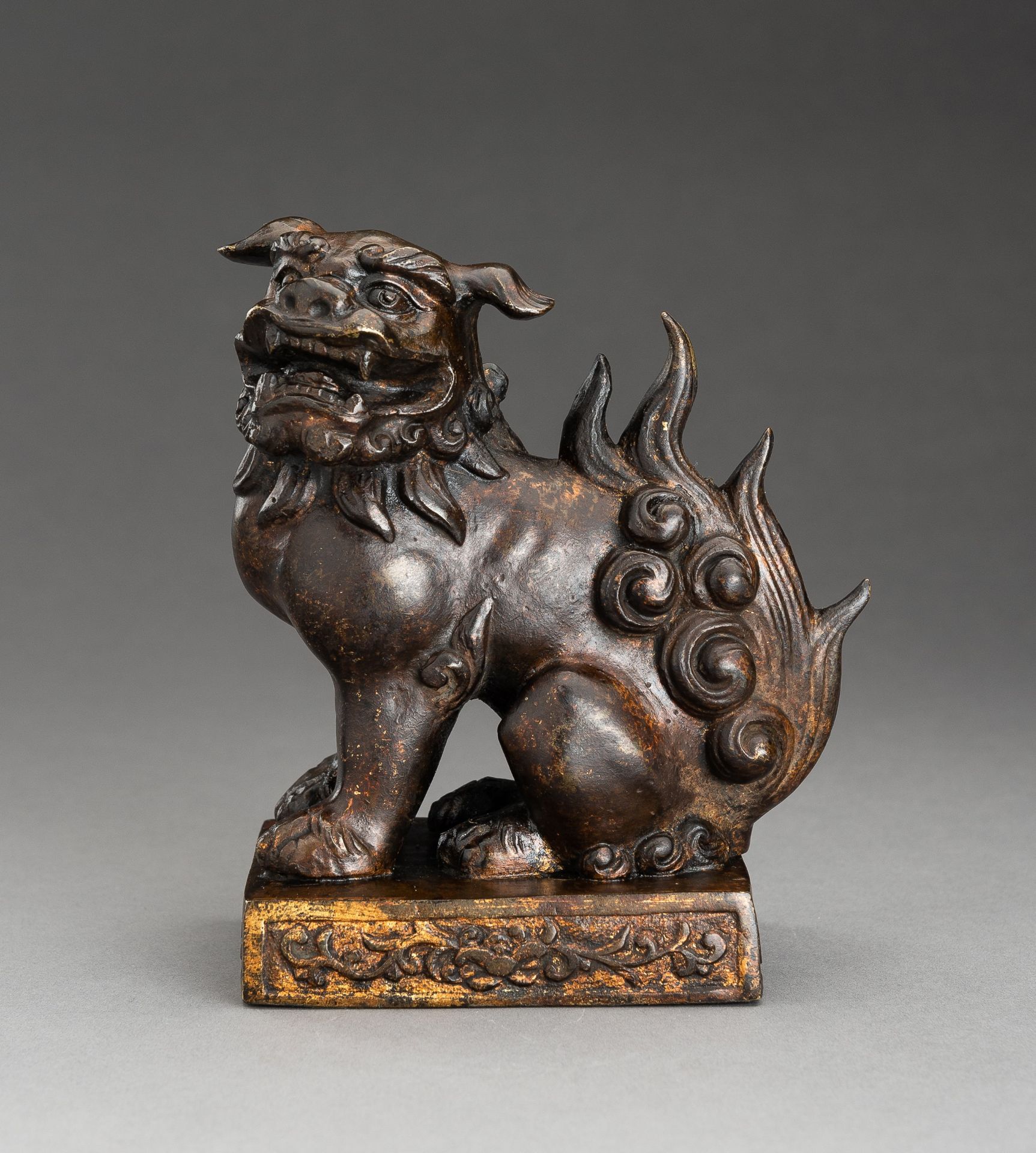 A LACQUER GILT BRONZE FIGURE OF A BUDDHIST LION, QING