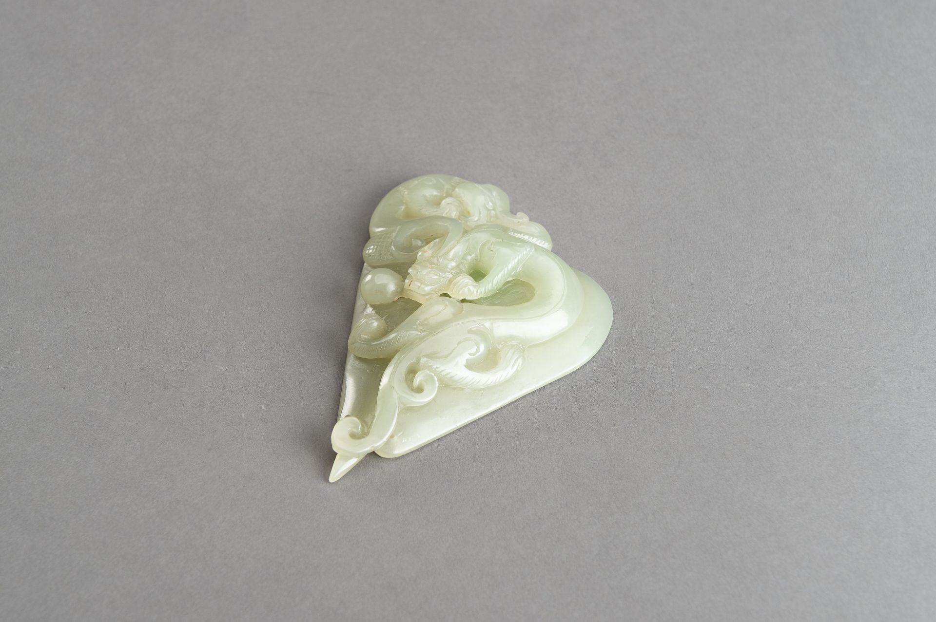 AN ARCHAISTIC PALE CELADON JADE PENDANT OF A CHILONG, 1920s - Image 7 of 14