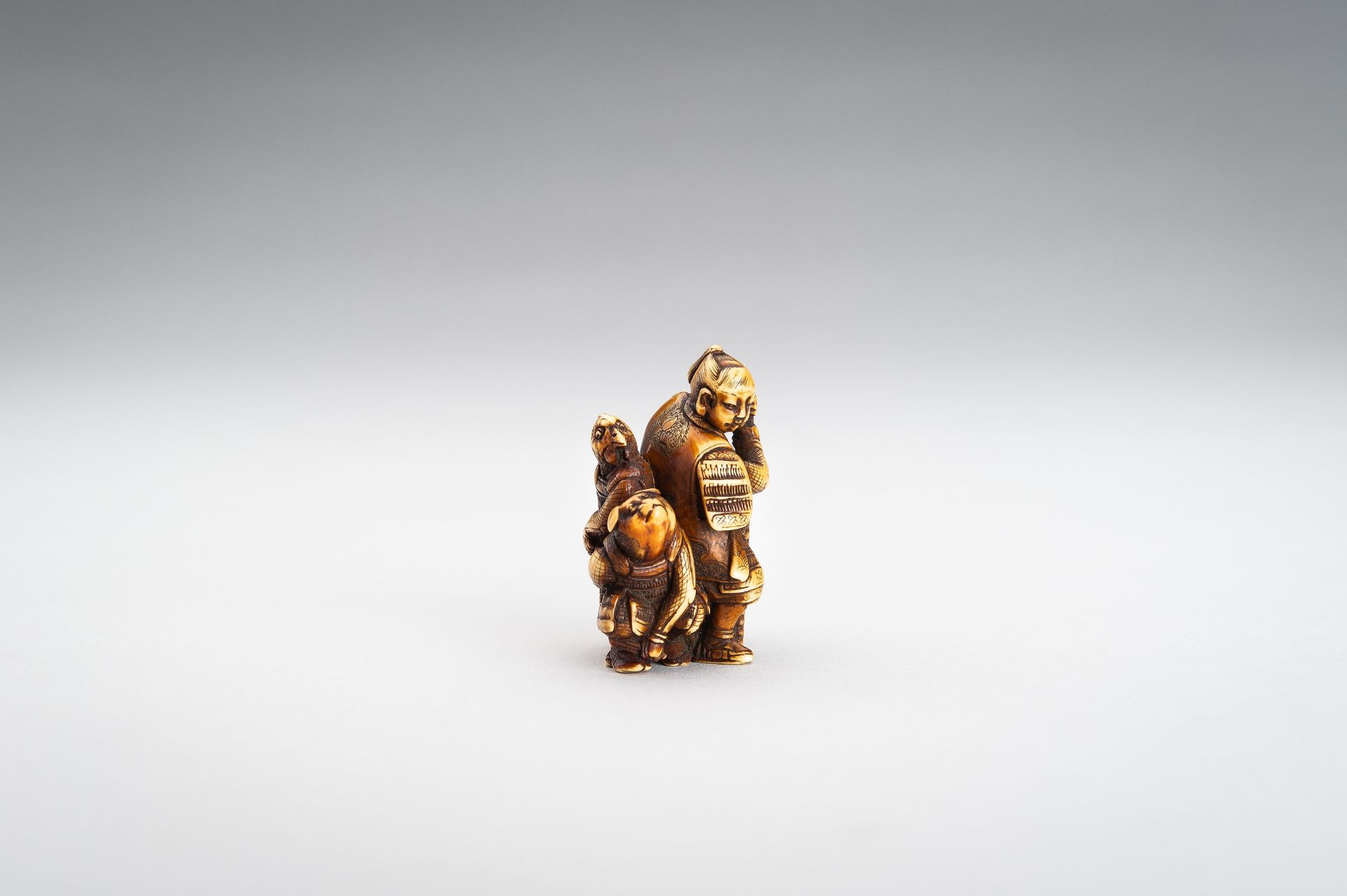 TOMOCHIKA: AN IVORY NETSUKE OF MOMOTARO WITH COMPANIONS - Image 8 of 11