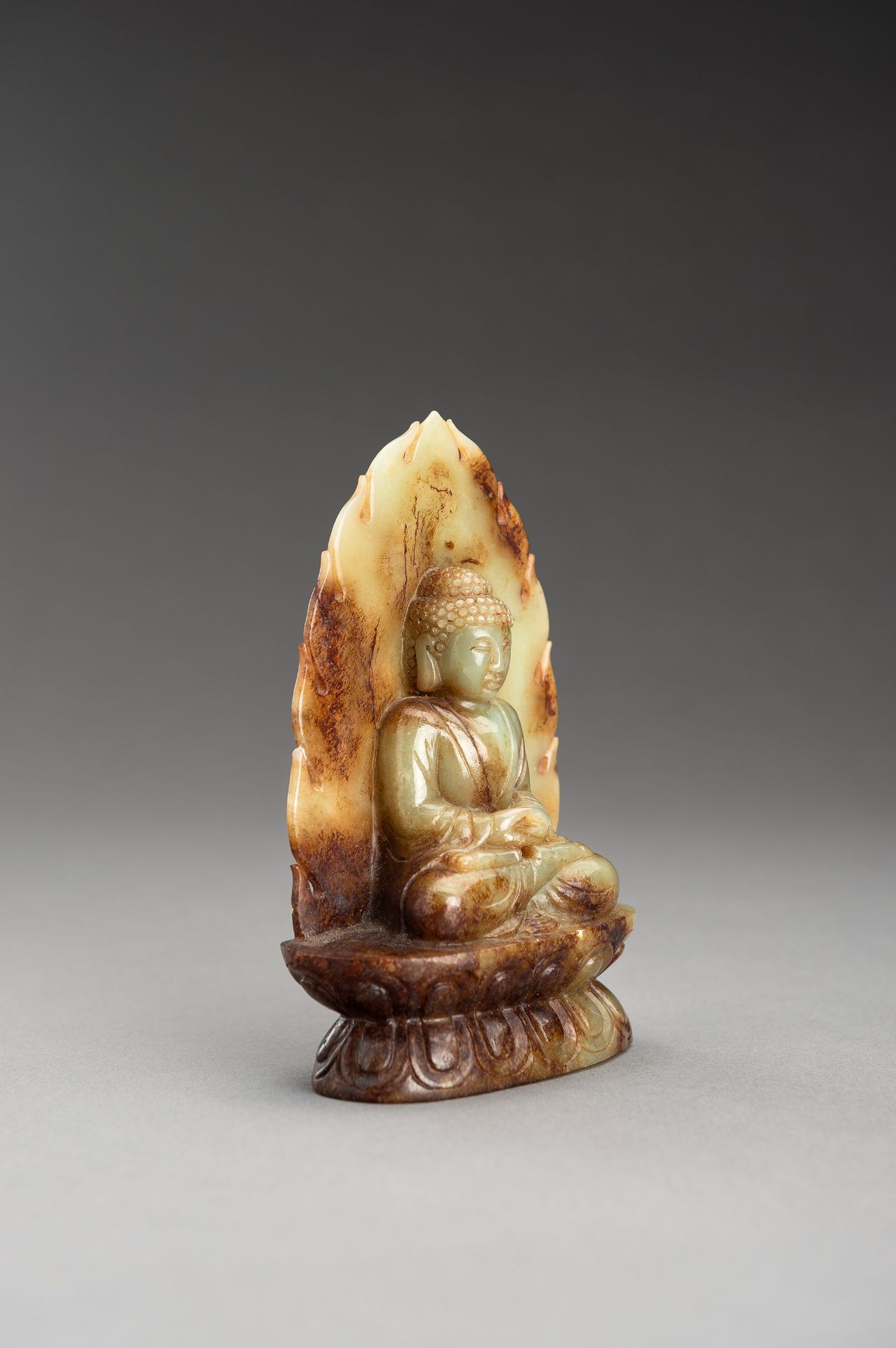 A PALE CELADON AND RUSSET JADE FIGURE OF BUDDHA - Image 8 of 10