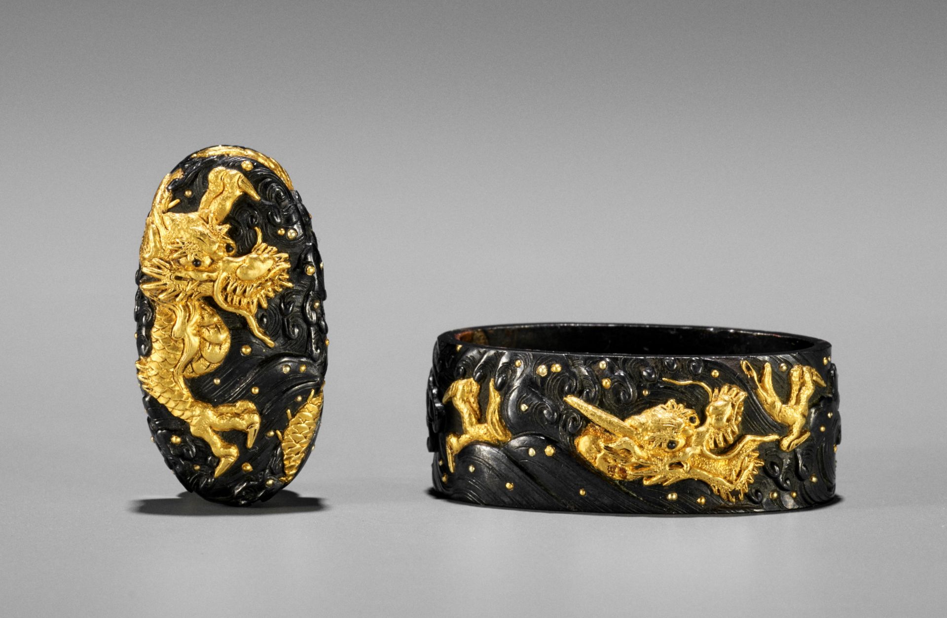 MASATOMO: A FINE SHAKUDO AND GOLD FUCHI AND KASHIRA WITH DRAGONS IN CRASHING WAVES