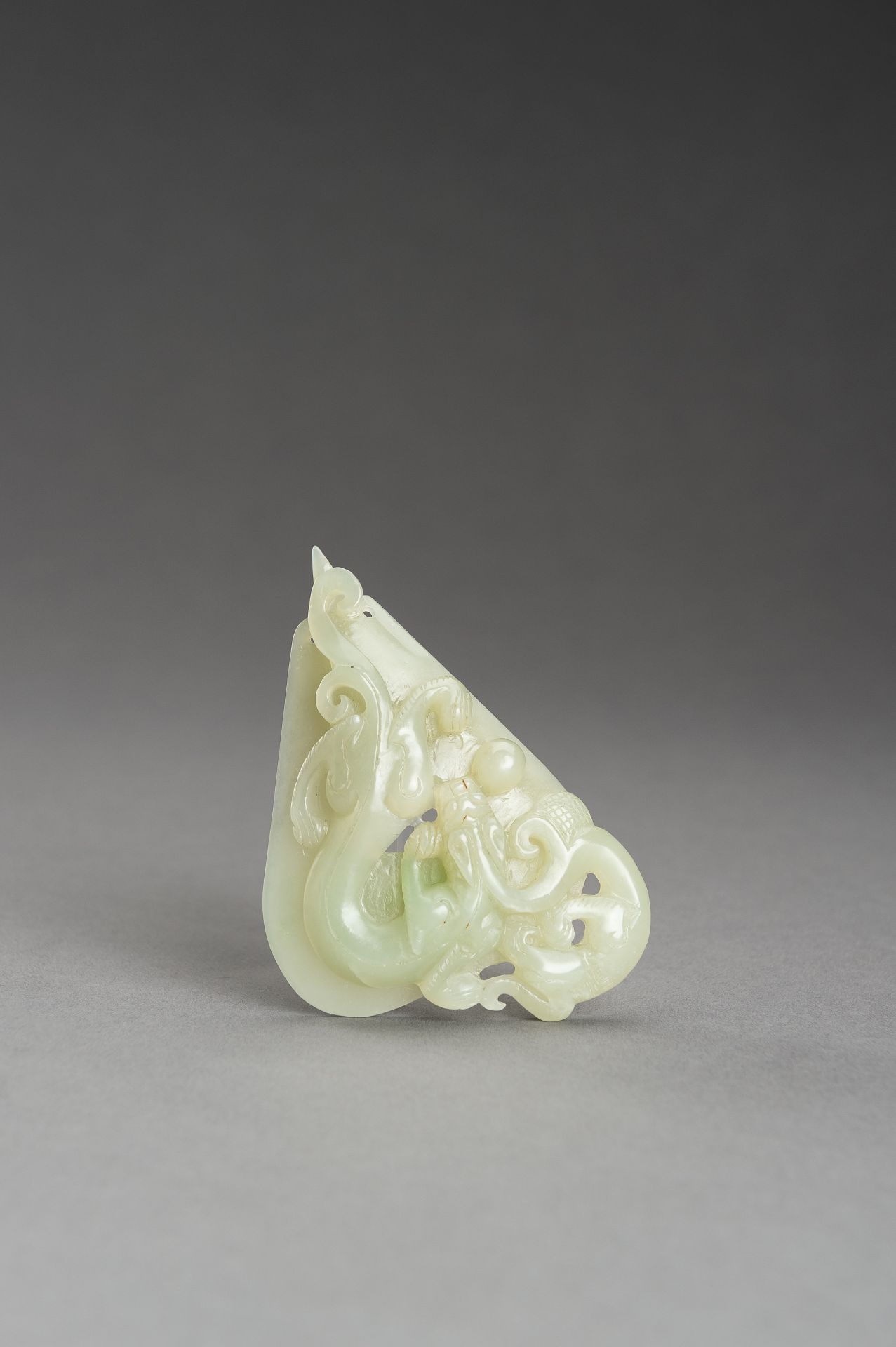 AN ARCHAISTIC PALE CELADON JADE PENDANT OF A CHILONG, 1920s - Image 12 of 14