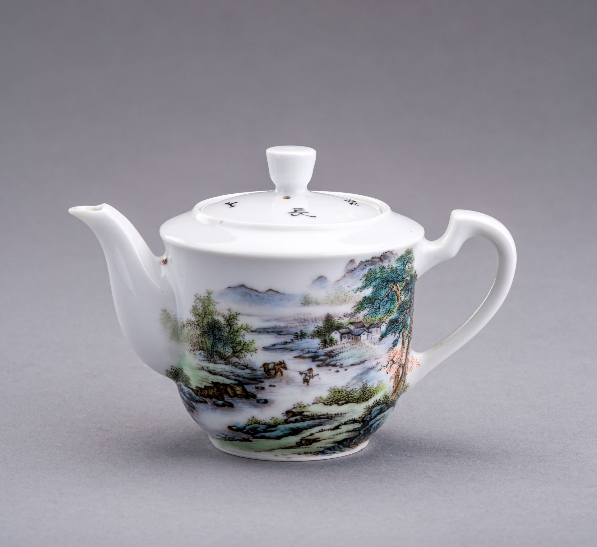 A SMALL ENAMELED PORCELAIN TEAPOT