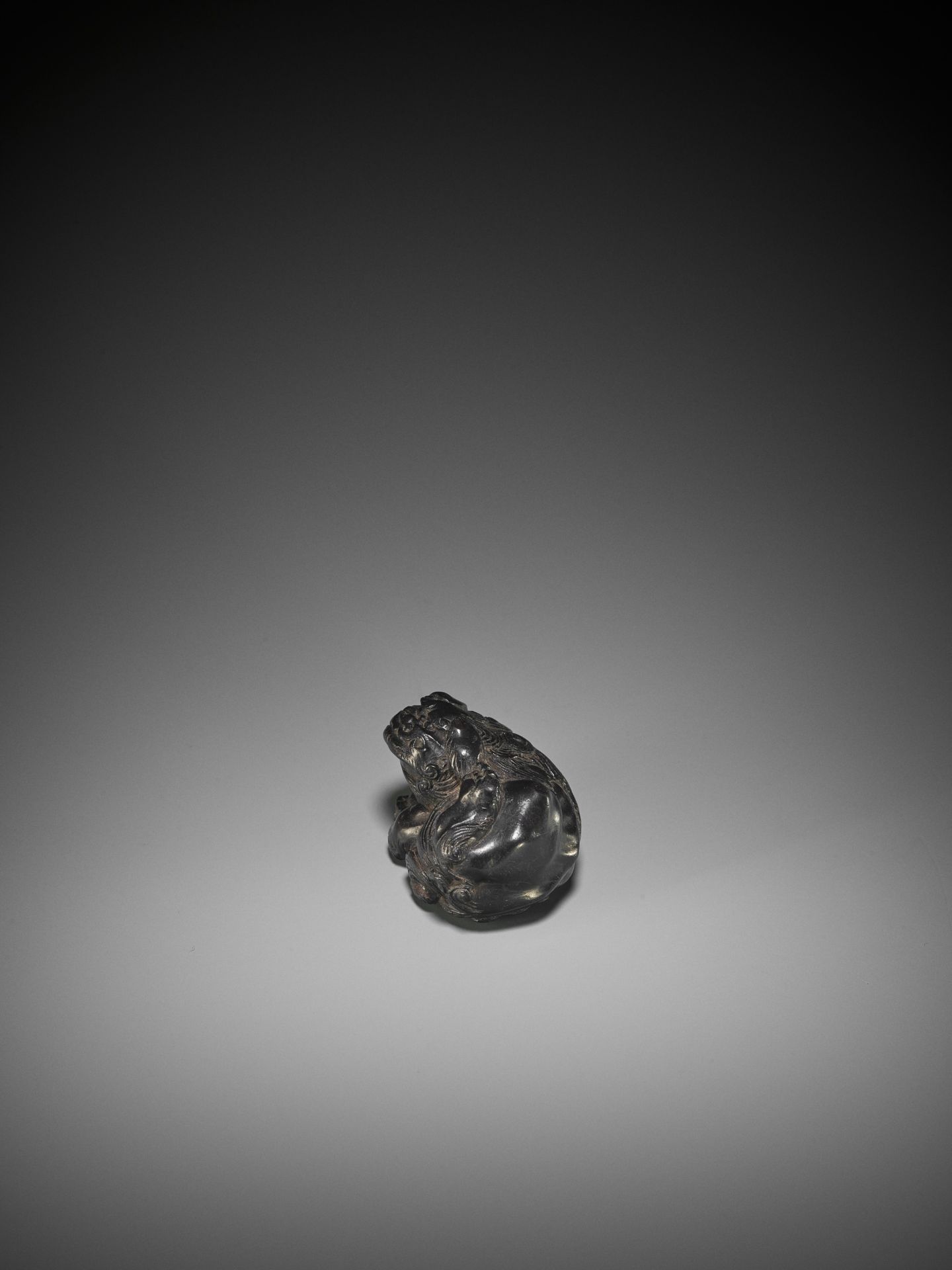 KOKEI: A RARE EBONY WOOD NETSUKE OF A SHISHI SCRATCHING HIS EAR - Image 5 of 10