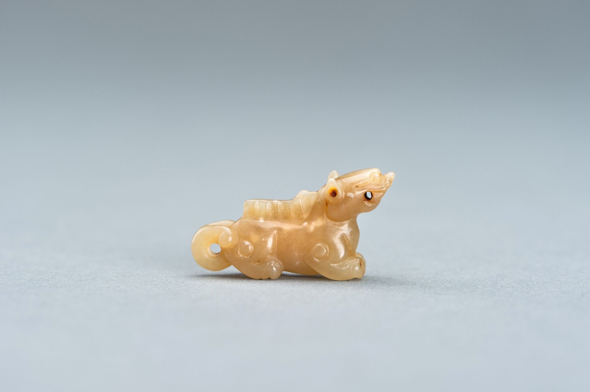 A PALE GREEN MINIATURE CARVING OF A LION, c. 1920s - Image 2 of 13