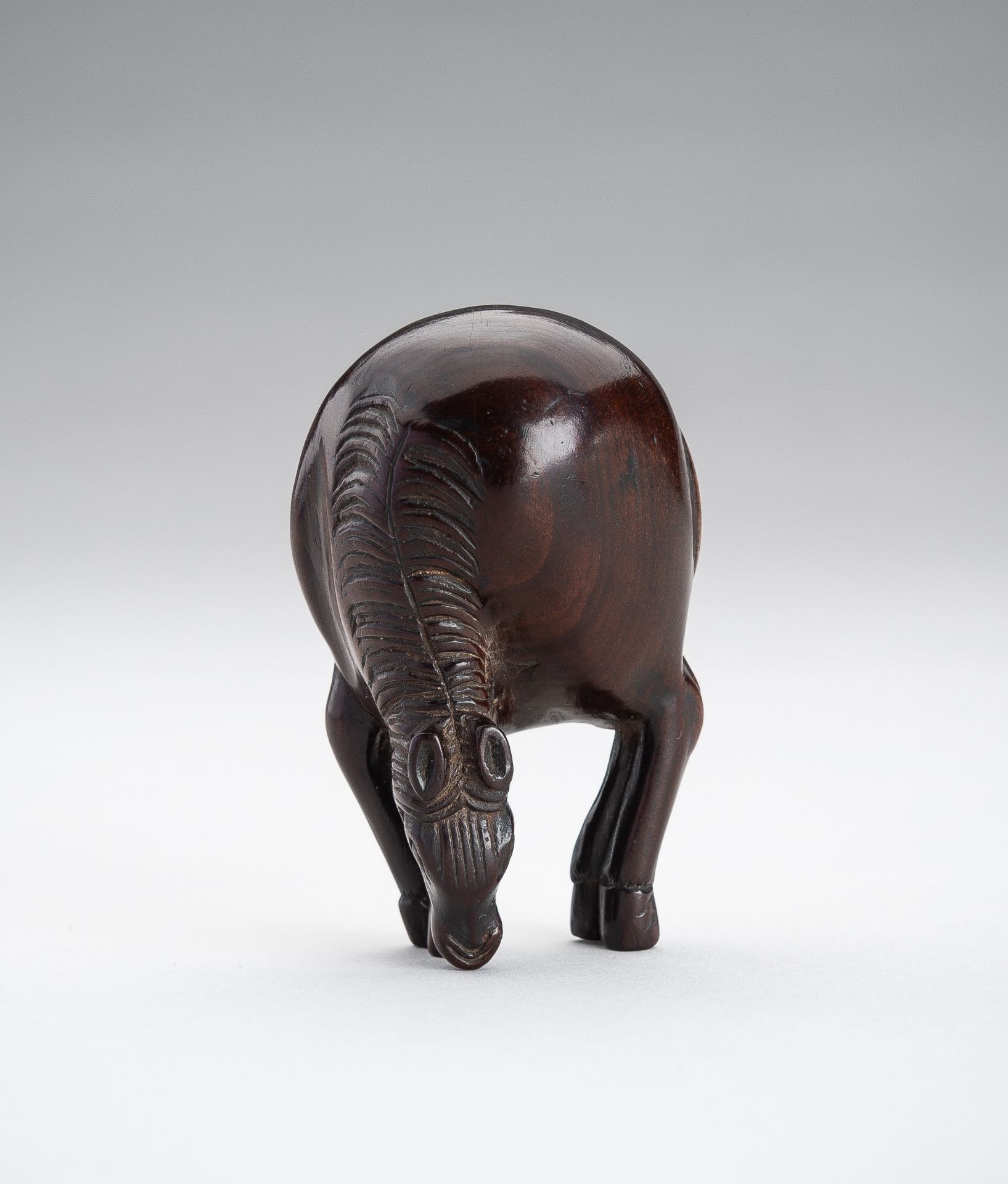 A LARGE WOOD NETSUKE OF A STANDING HORSE
