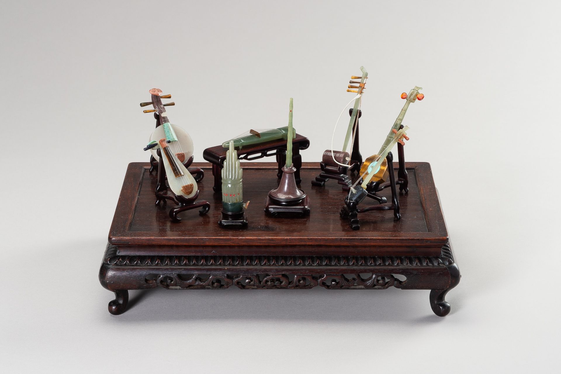 A GROUP OF EIGHT HARDSTONE MINIATURE MODELS OF MUSICAL INSTRUMENTS