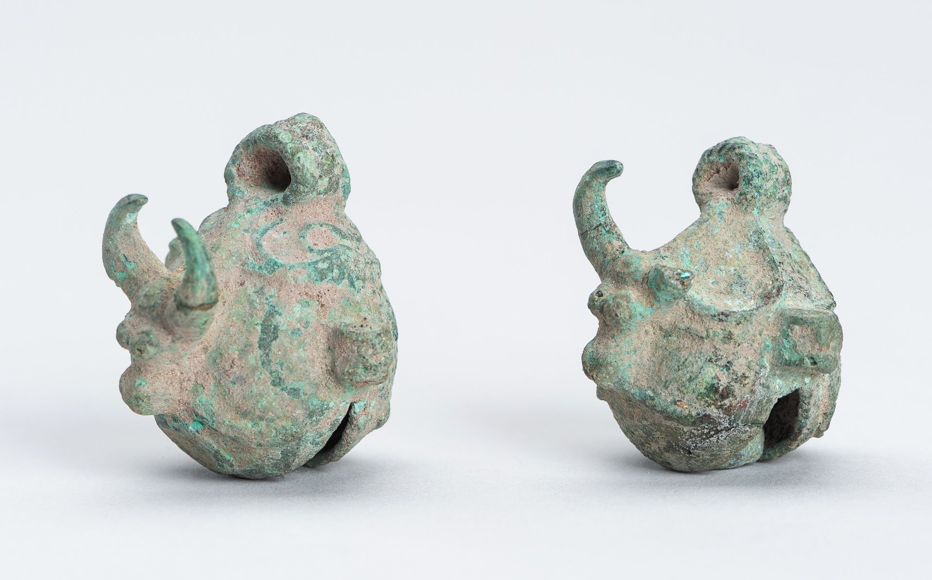 A PAIR OF DONG SON 'BULL'S HEAD' BRONZE BELLS