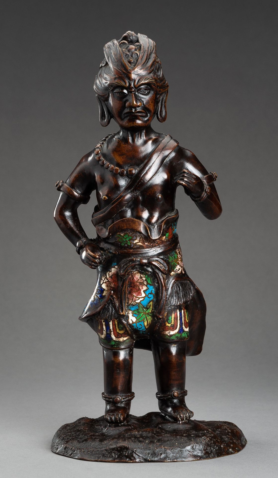 A CHAMPLEVE BRONZE FIGURE OF A GUARDIAN, c. 1920s