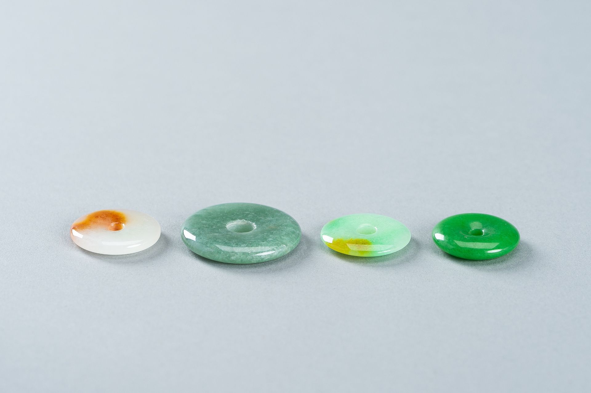 A GROUP OF FOUR JADEITE DISC PENDANTS - Image 7 of 10