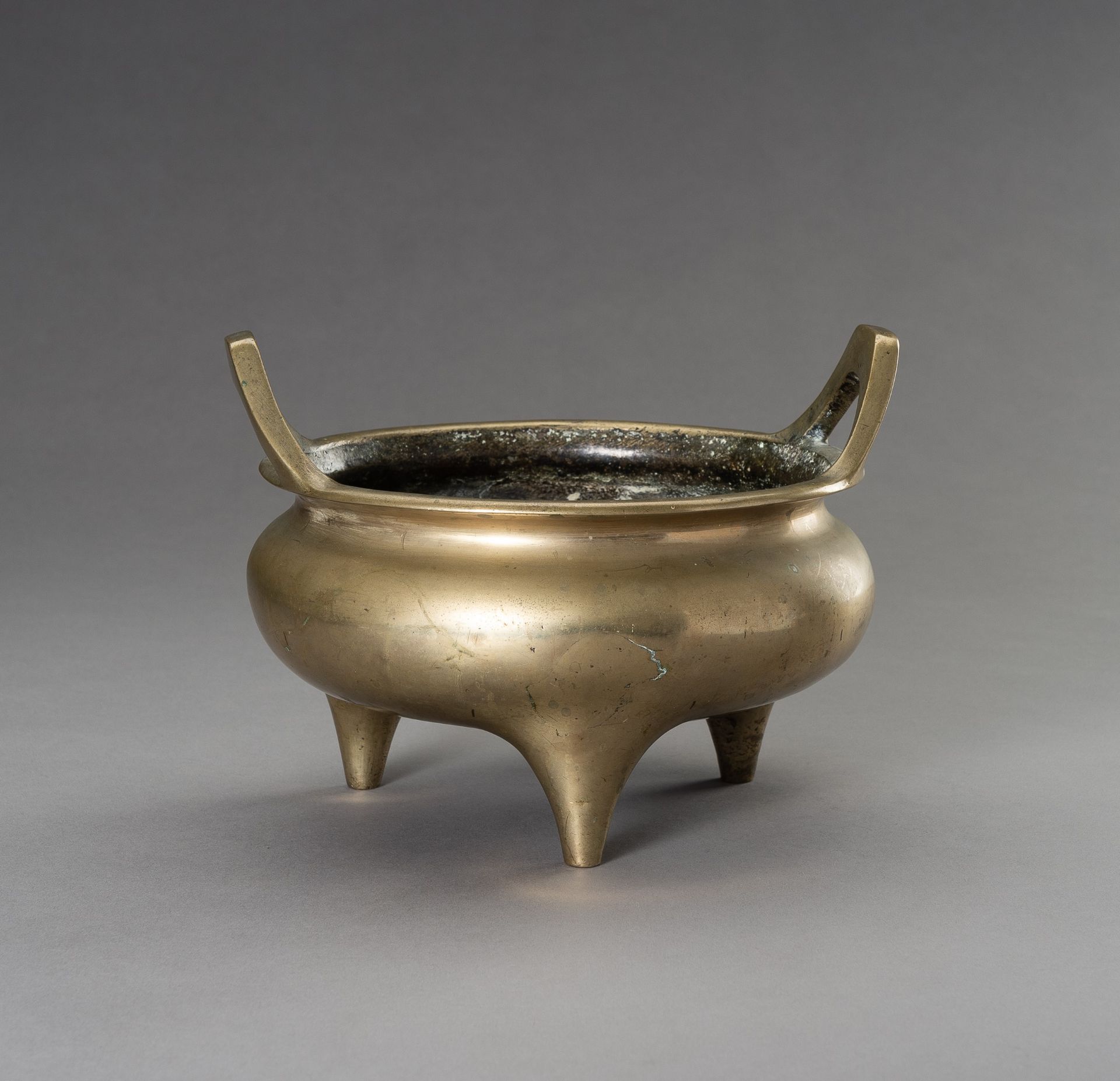 A LARGE GILT BRONZE TRIPOD CENSER