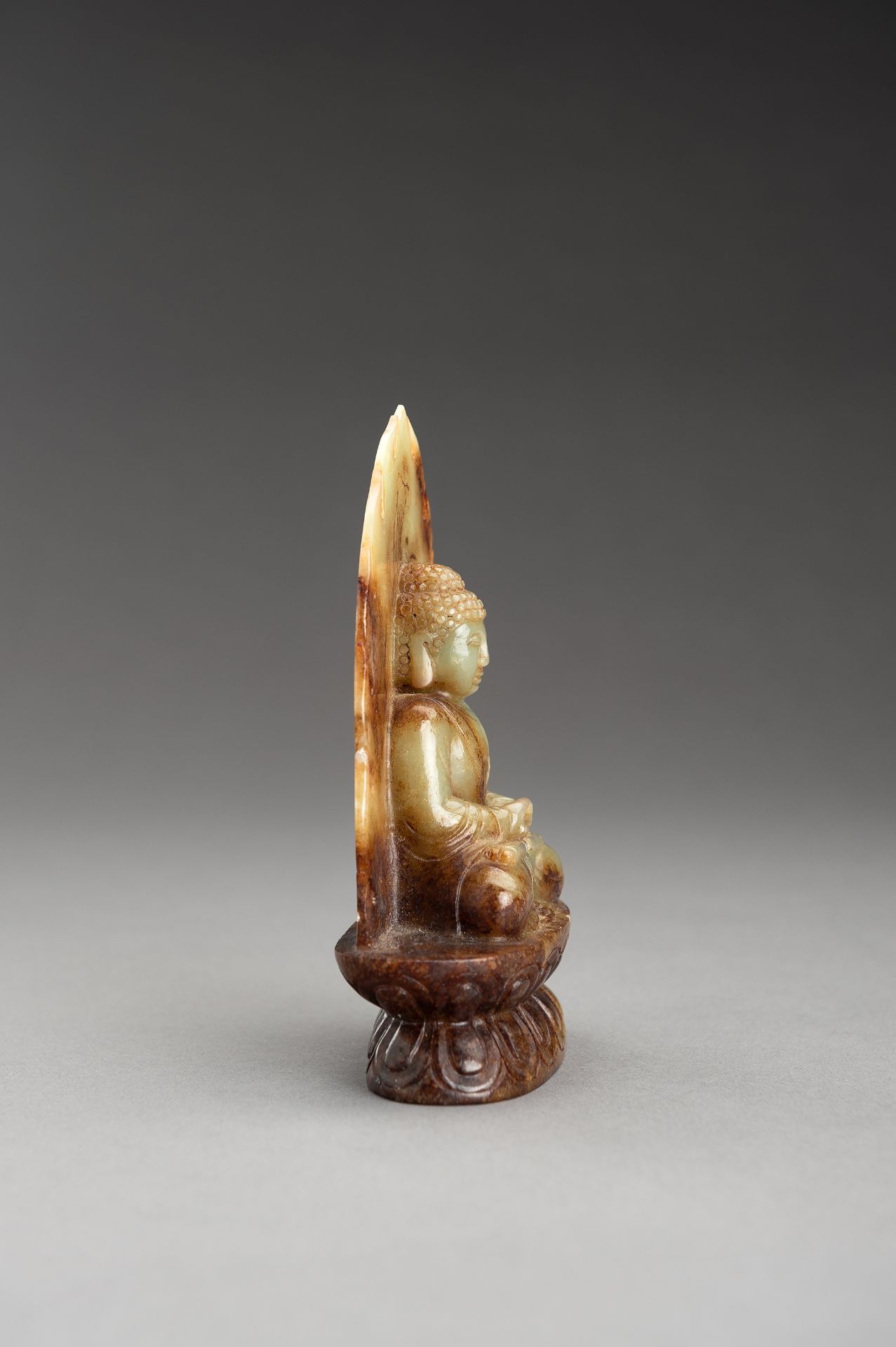 A PALE CELADON AND RUSSET JADE FIGURE OF BUDDHA - Image 7 of 10