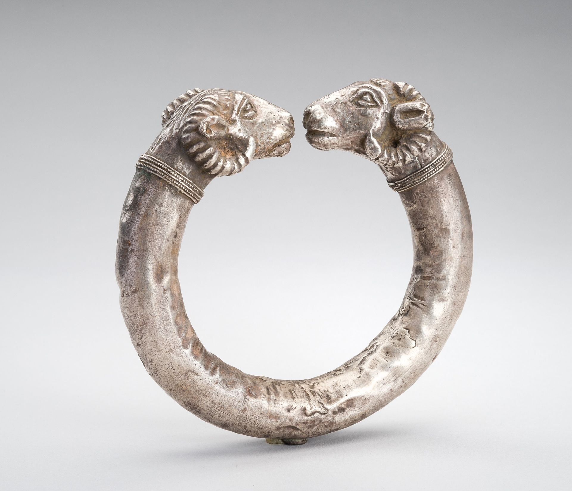 AN ACHAEMENID SILVER RAM-HEADED BRACELET