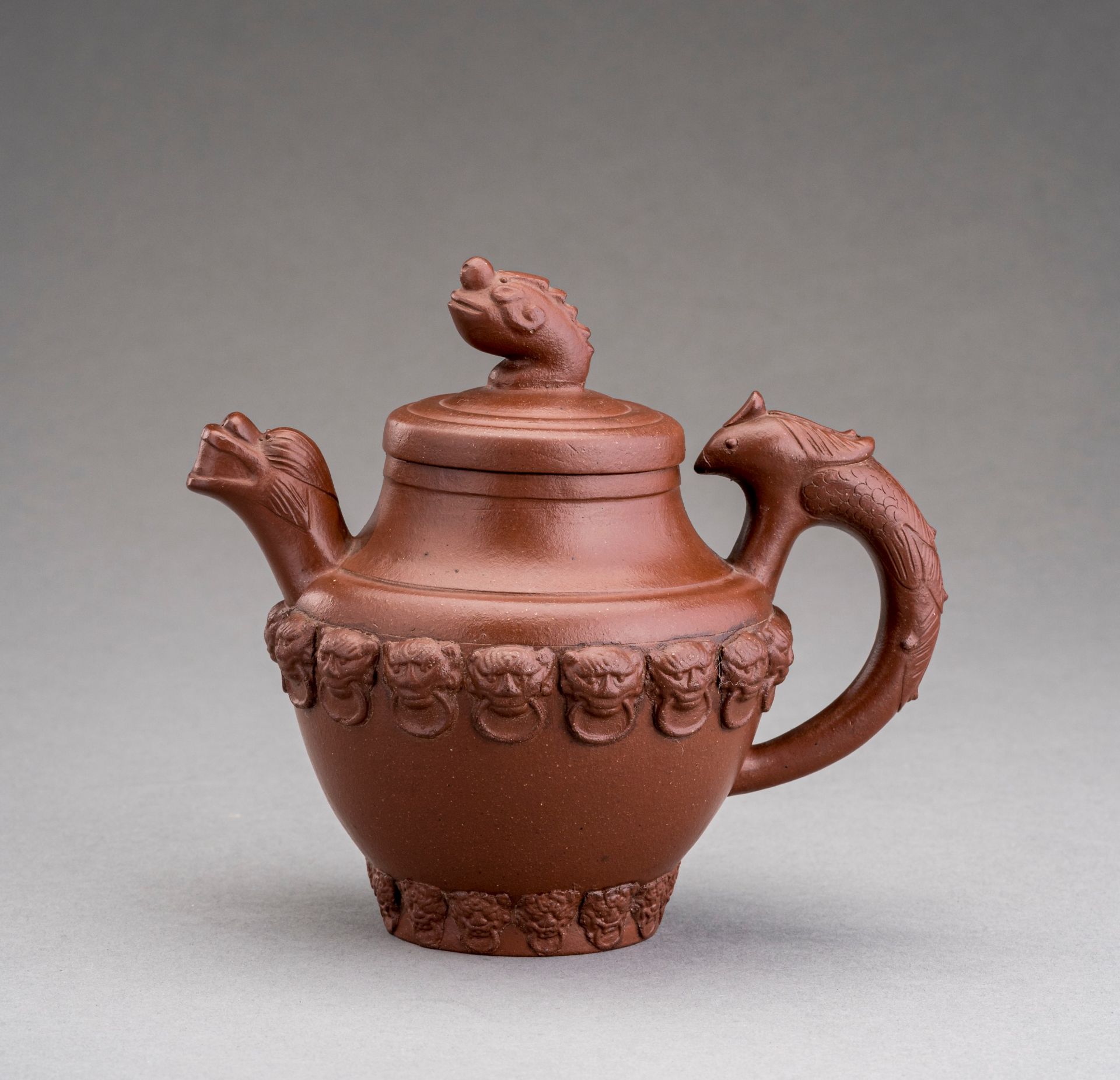 A YIXING ZISHA 'MYTHICAL BEASTS' TEAPOT AND COVER