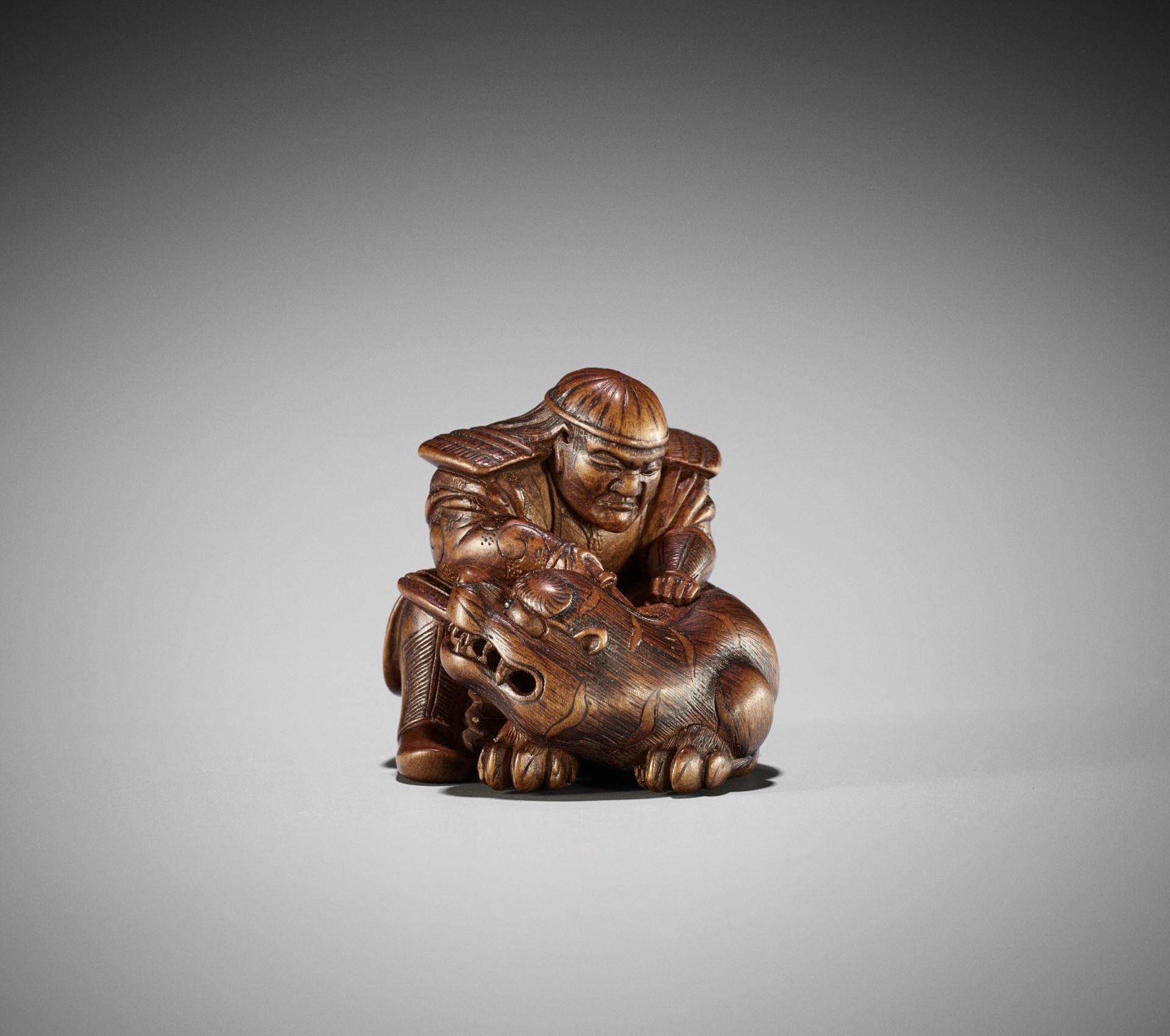 MASAKATA: A FINE AND RARE WOOD NETSUKE OF HADESU SLAYING THE TIGER