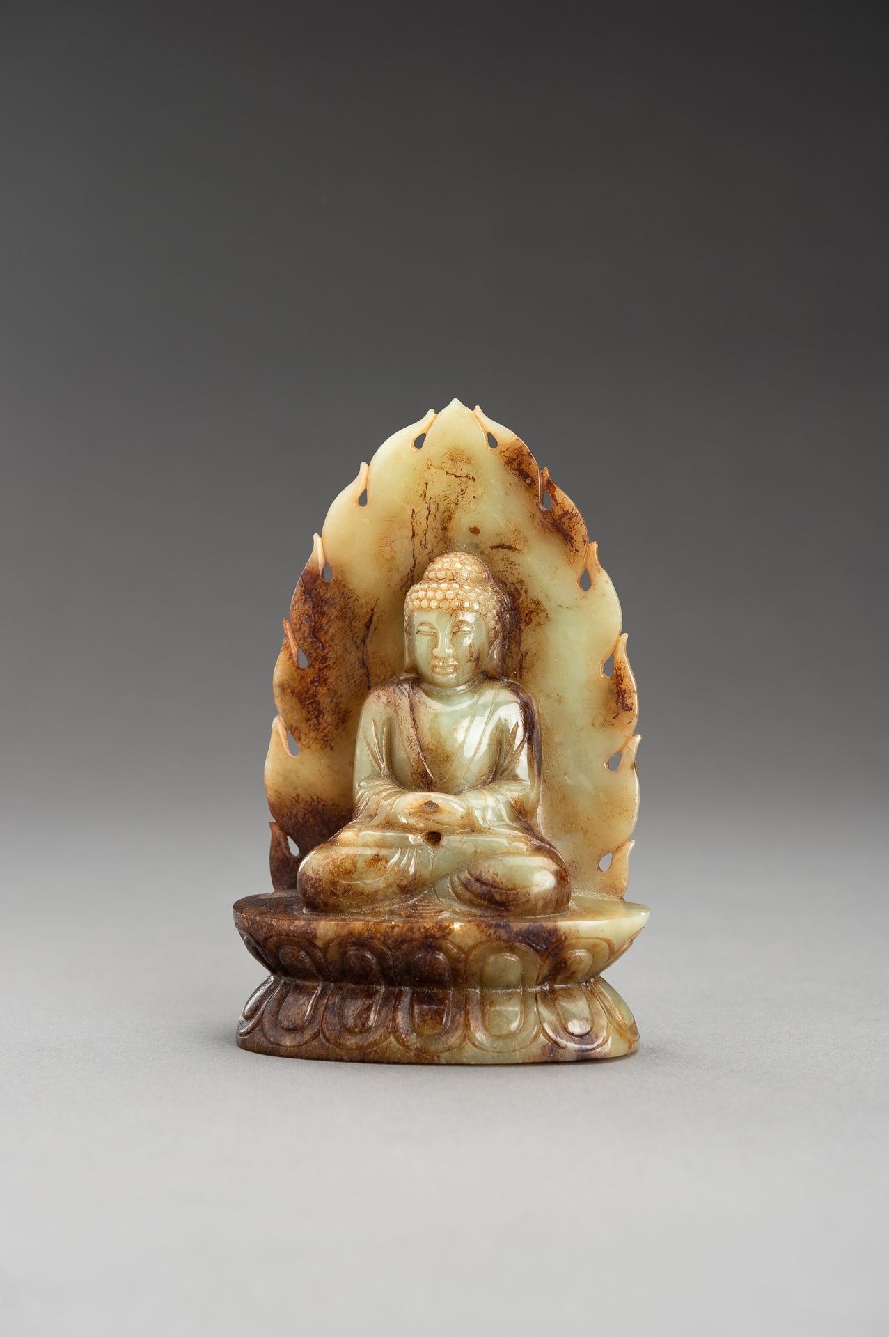 A PALE CELADON AND RUSSET JADE FIGURE OF BUDDHA - Image 2 of 10